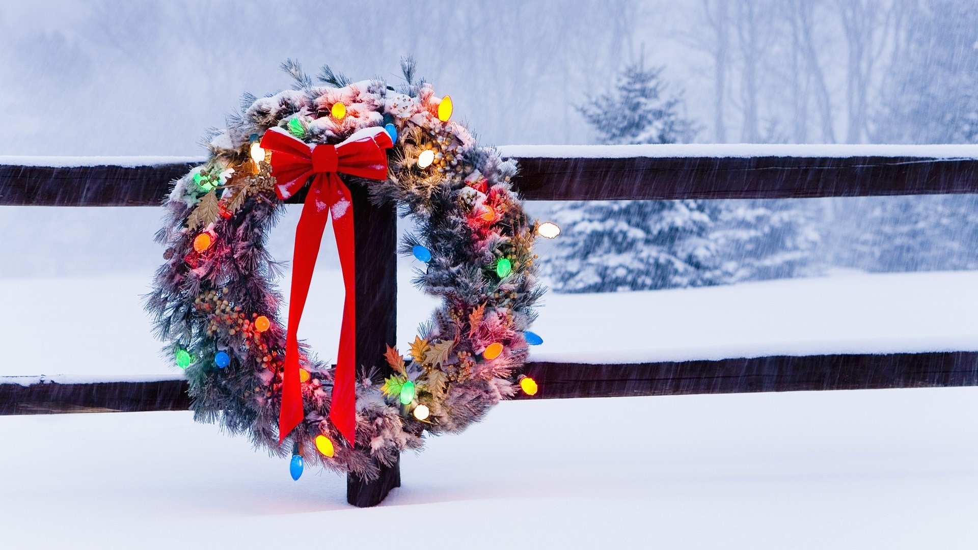 Christmas wreath with lights on a snowy fence HD Wallpaper