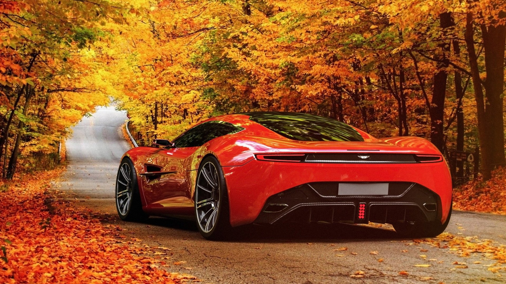 Red Aston Martin supercar on a road in autumn HD Wallpaper
