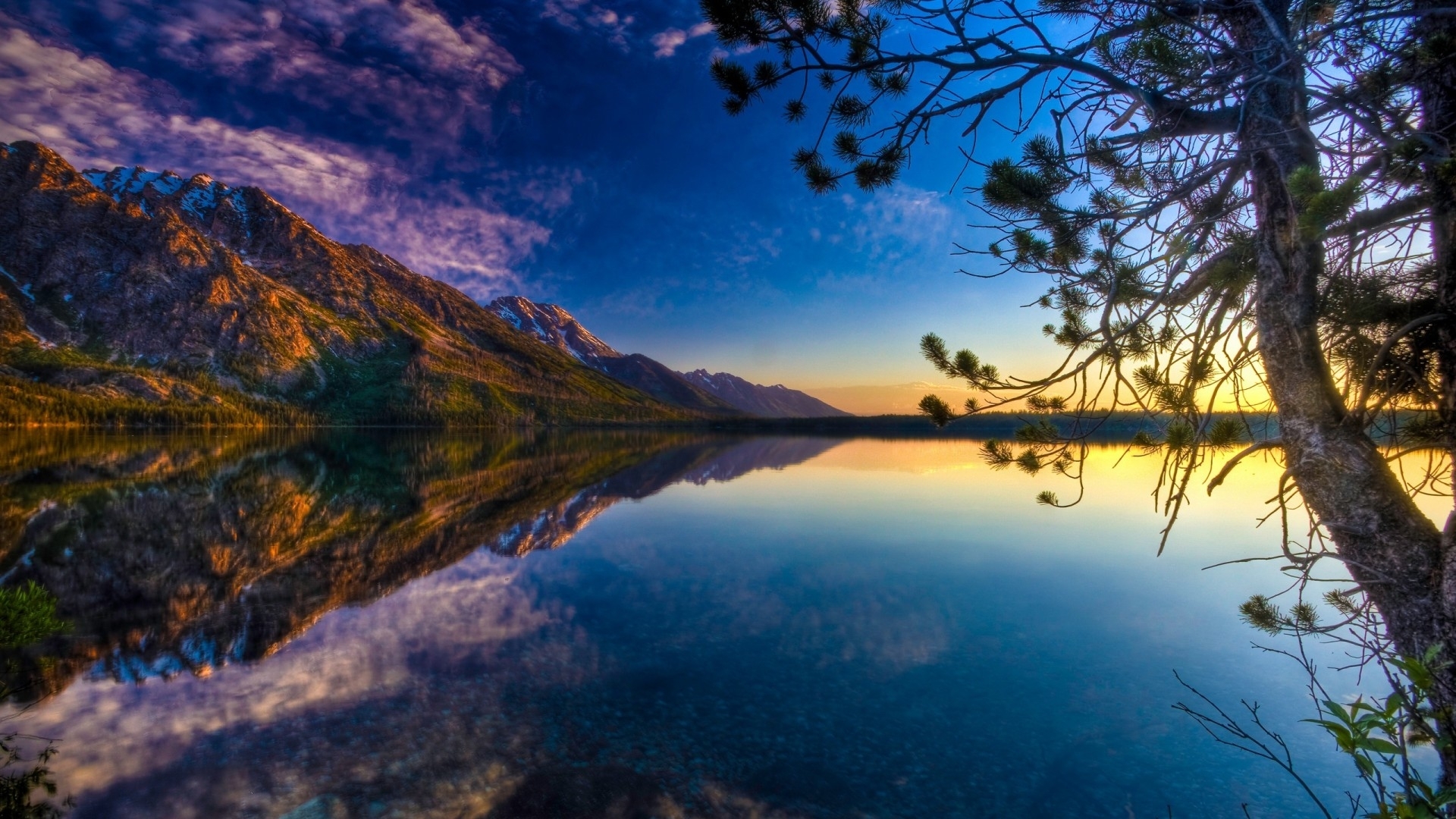 Mountain reflection on a lake at sunset with trees HD Wallpaper