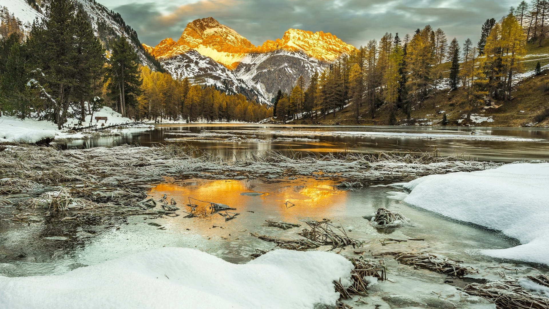 Winter sunset over a frozen lake in the Swiss Alps HD Wallpaper