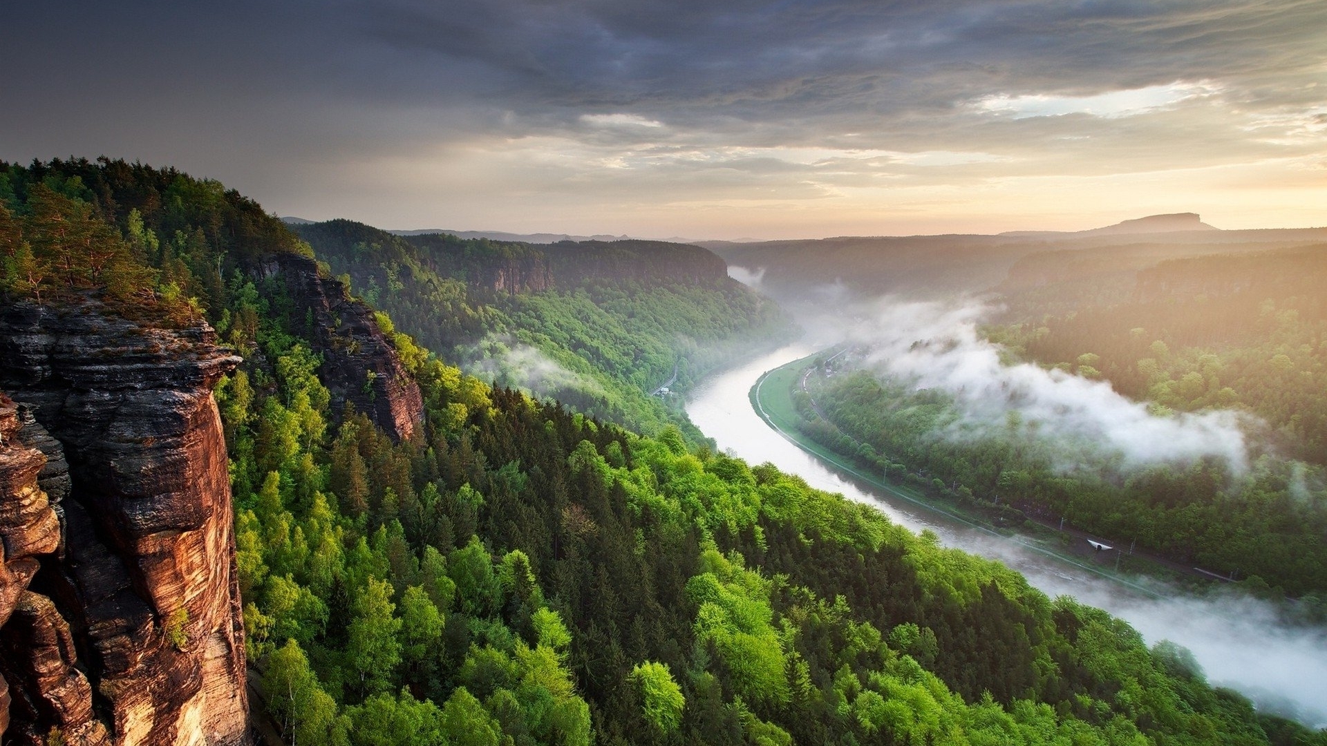 Misty river valley with forested mountains at sunrise HD Wallpaper