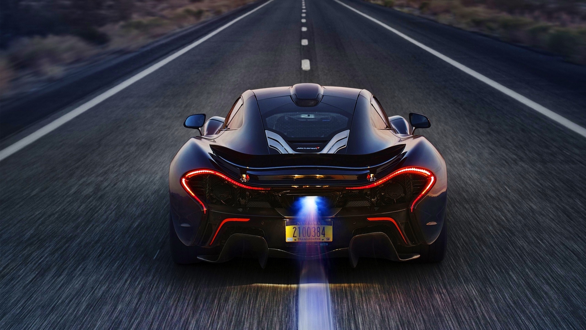 McLaren P1 on Open Road at Dusk HD Wallpaper