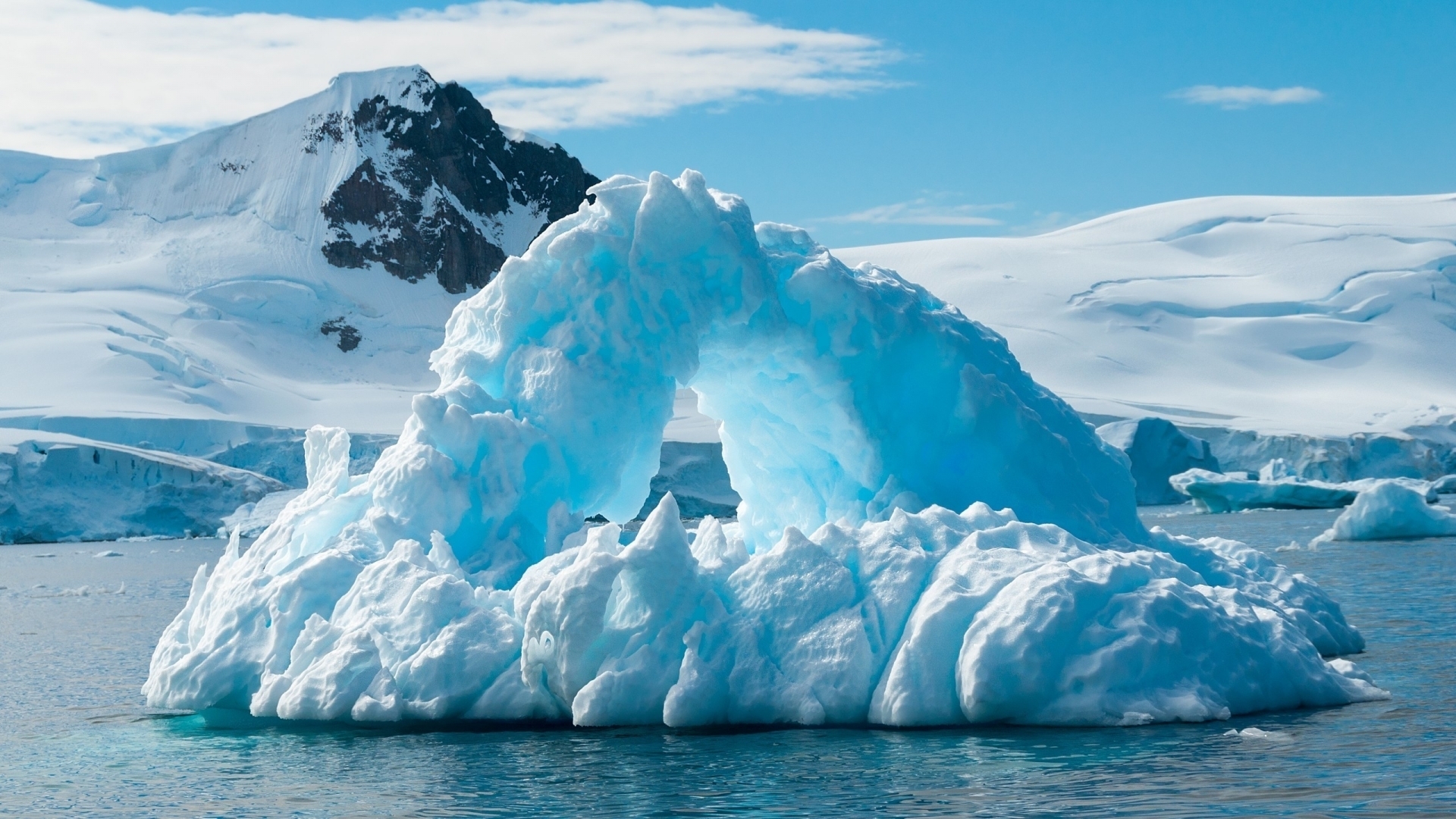 Arch-shaped iceberg in the Antarctic sea HD Wallpaper