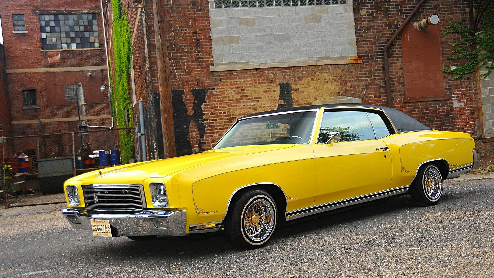 Yellow classic Chevrolet Monte Carlo in an alley HD Wallpaper