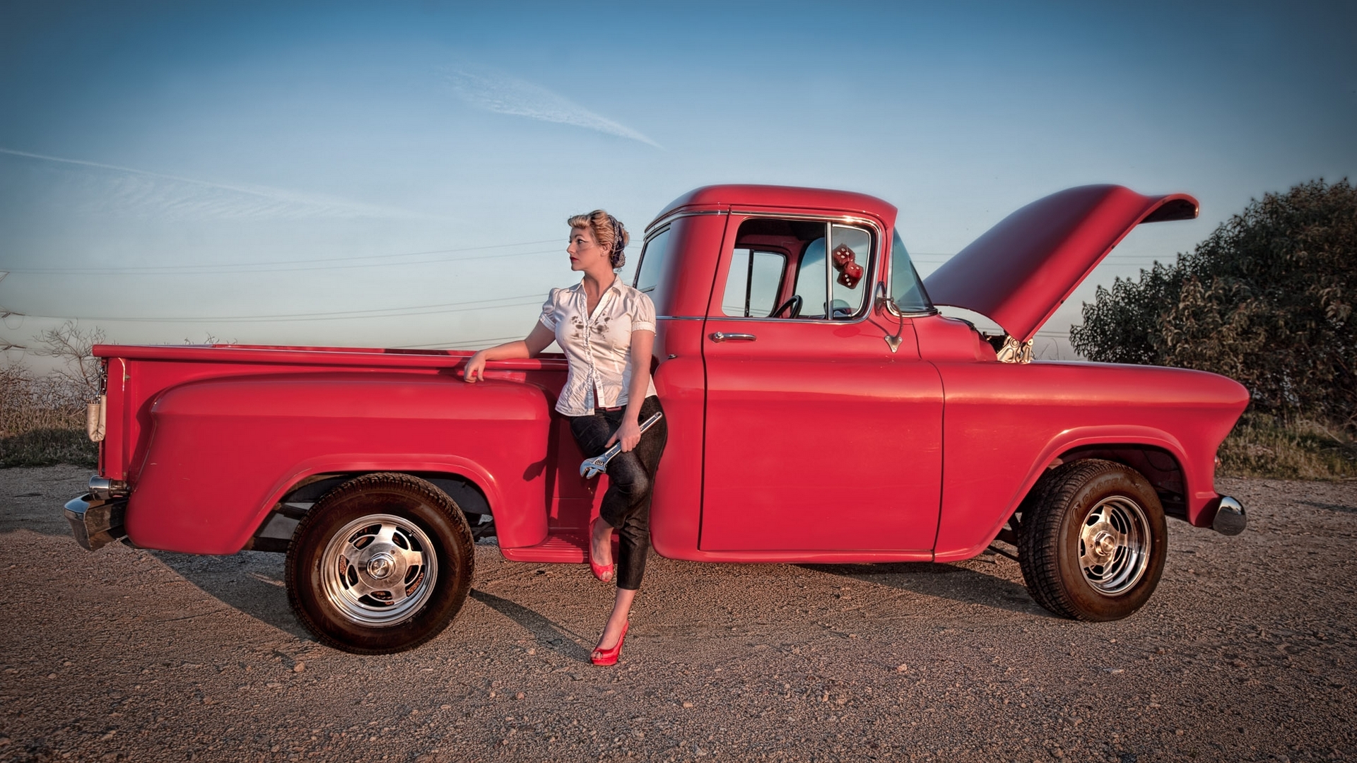 Woman with wrench leaning on red classic truck HD Wallpaper