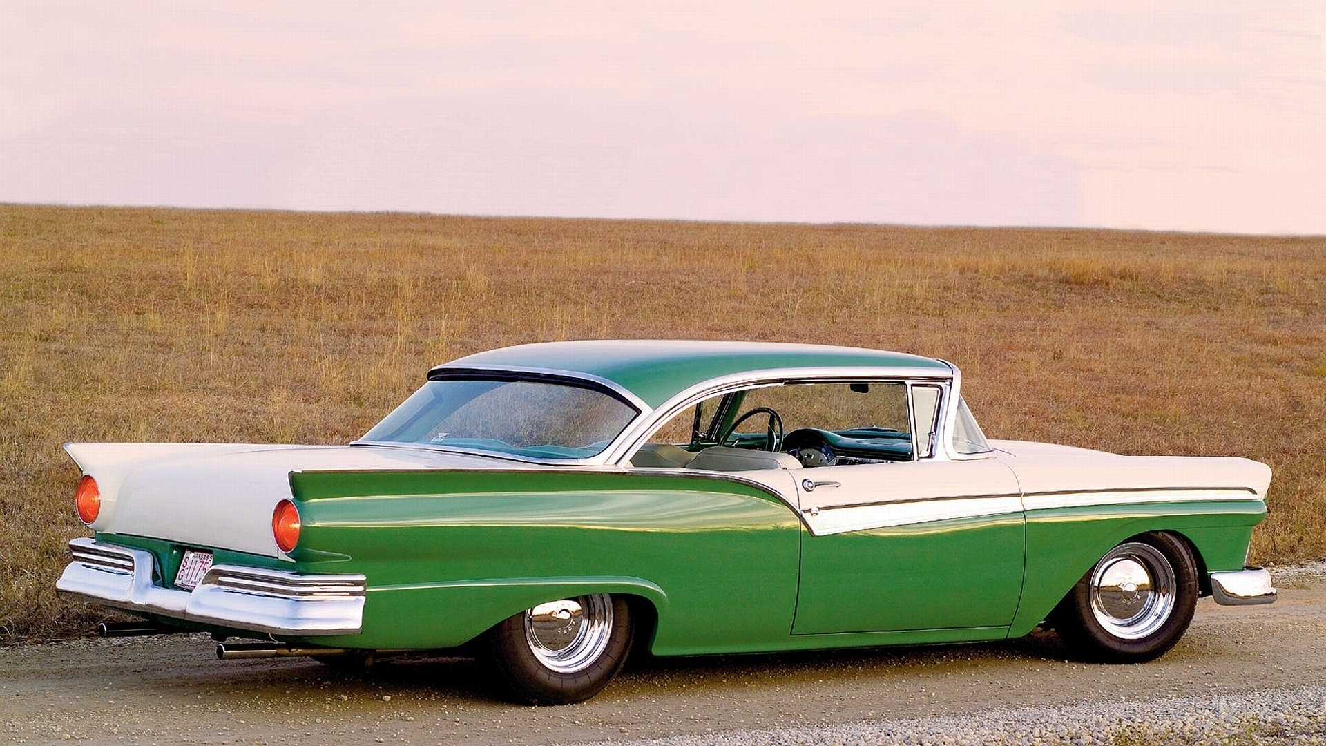 Green and white 1957 Ford Fairlane parked on a dirt road HD Wallpaper