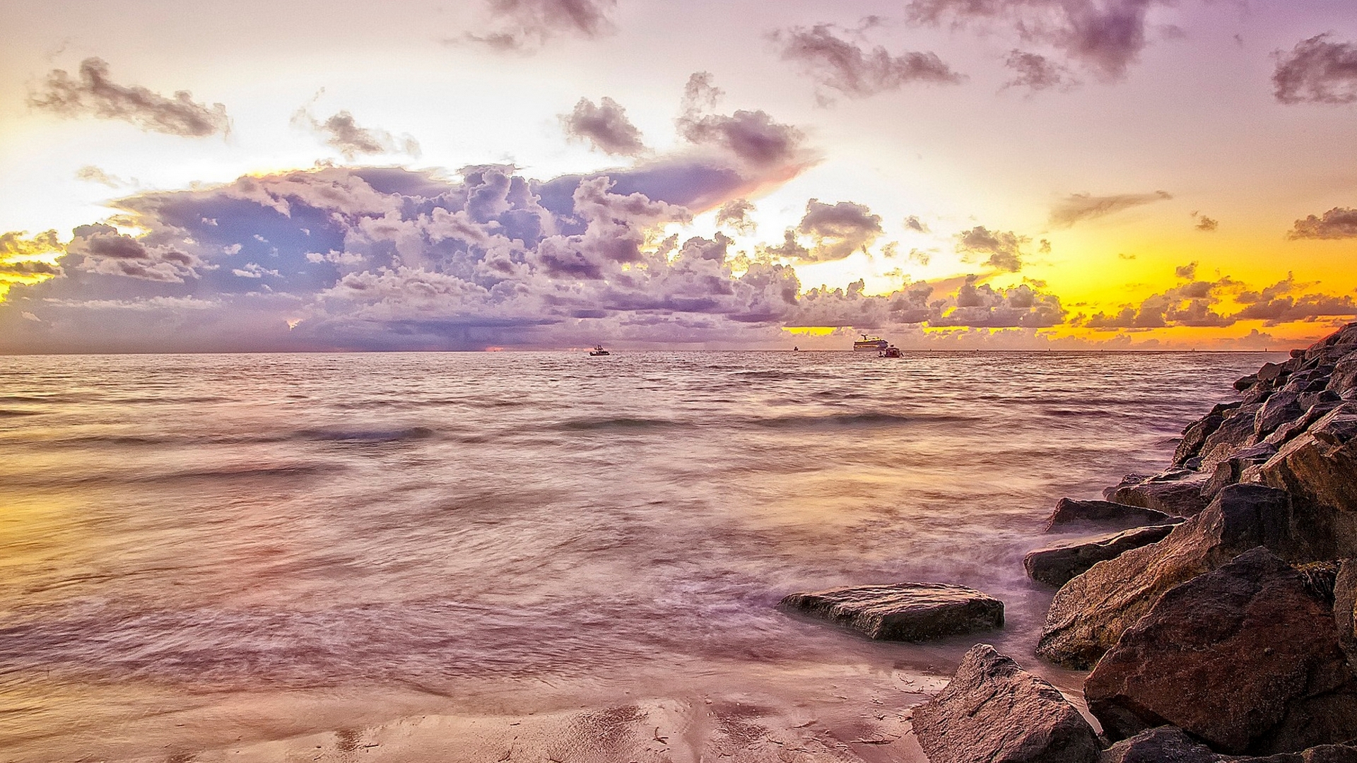 Colorful sunset over the sea with boats and rocks HD Wallpaper
