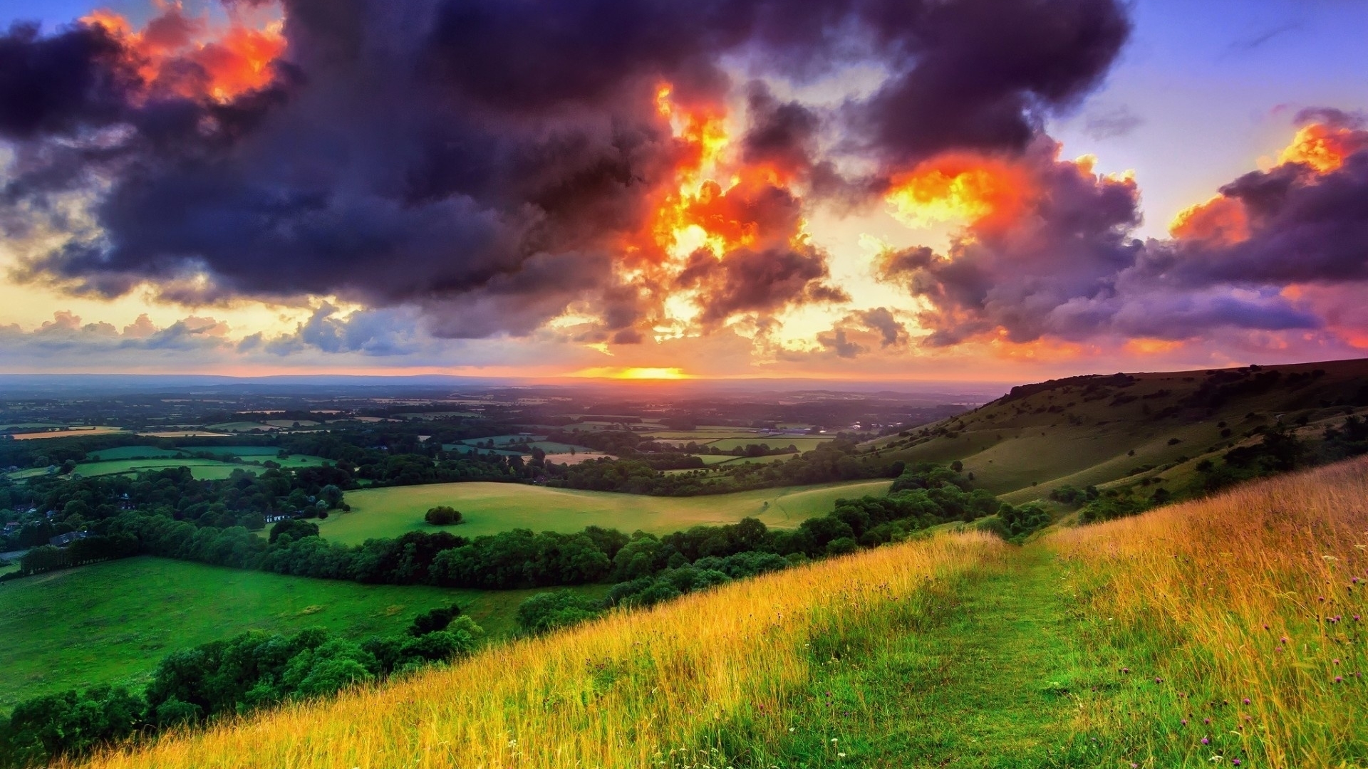 Sunset Over Rolling Fields and Dramatic Clouds HD Wallpaper