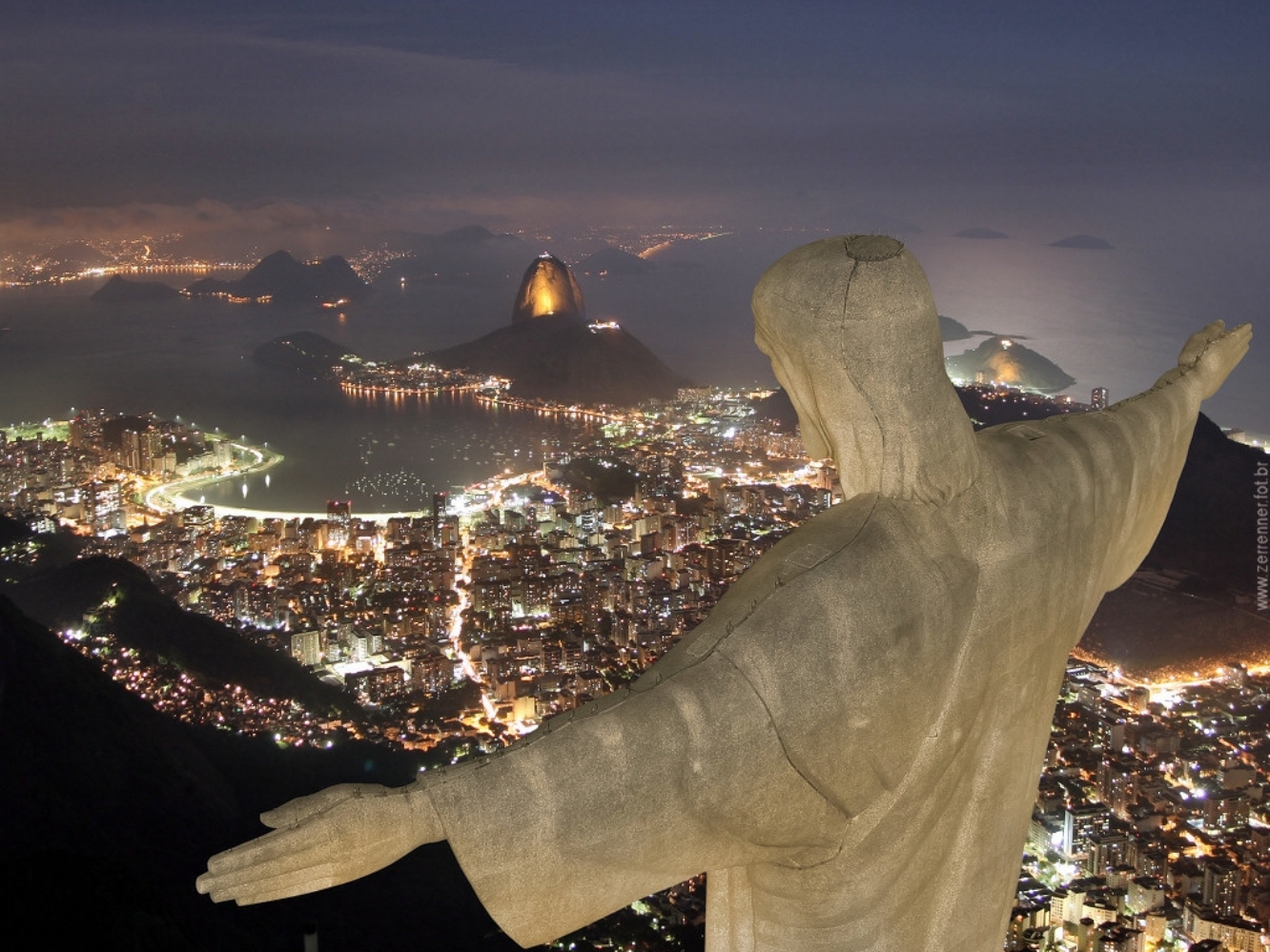 Christ the Redeemer statue overlooking Rio de Janeiro at night HD Wallpaper