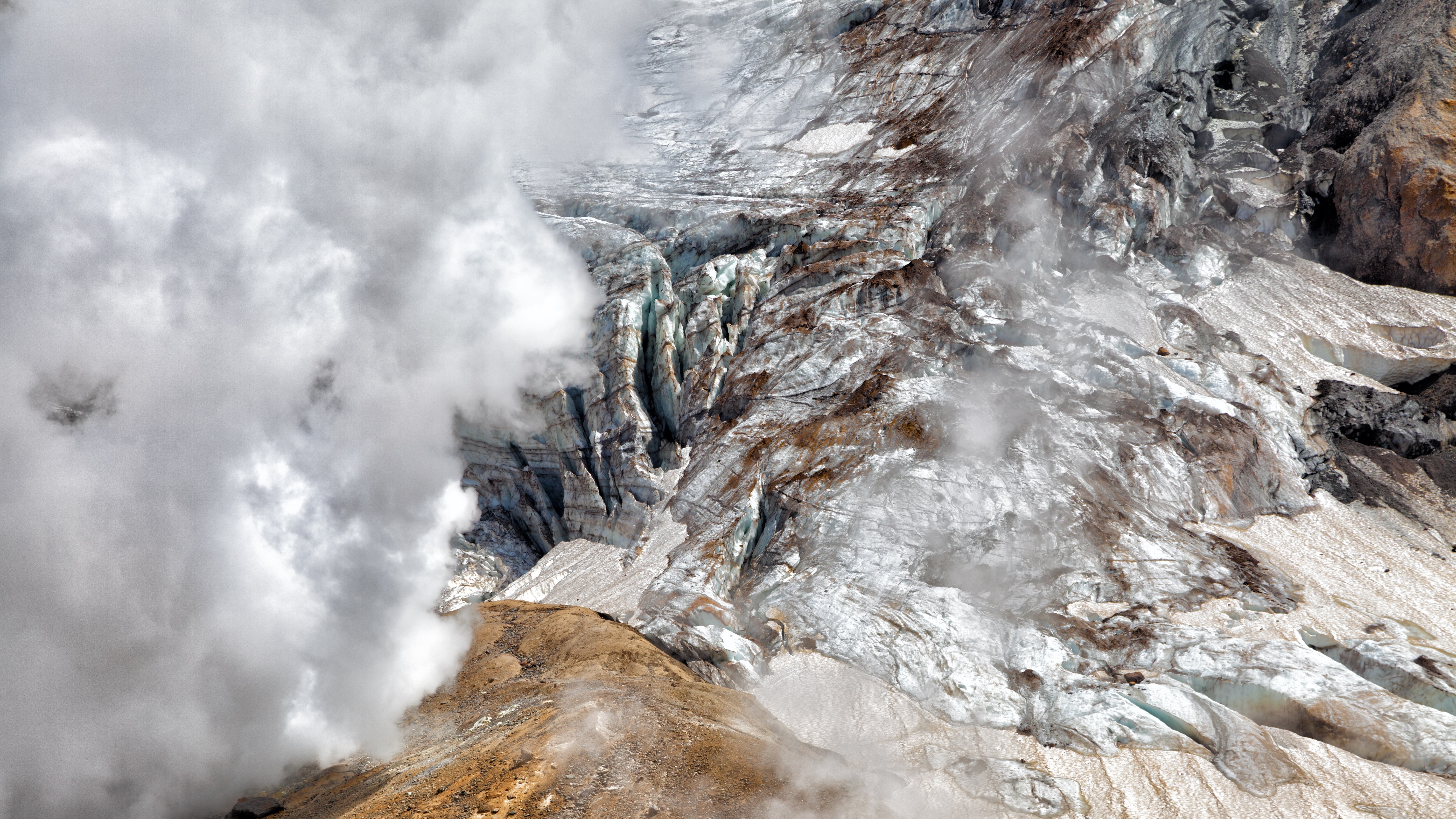 Volcanic glacier with steam vents HD Wallpaper