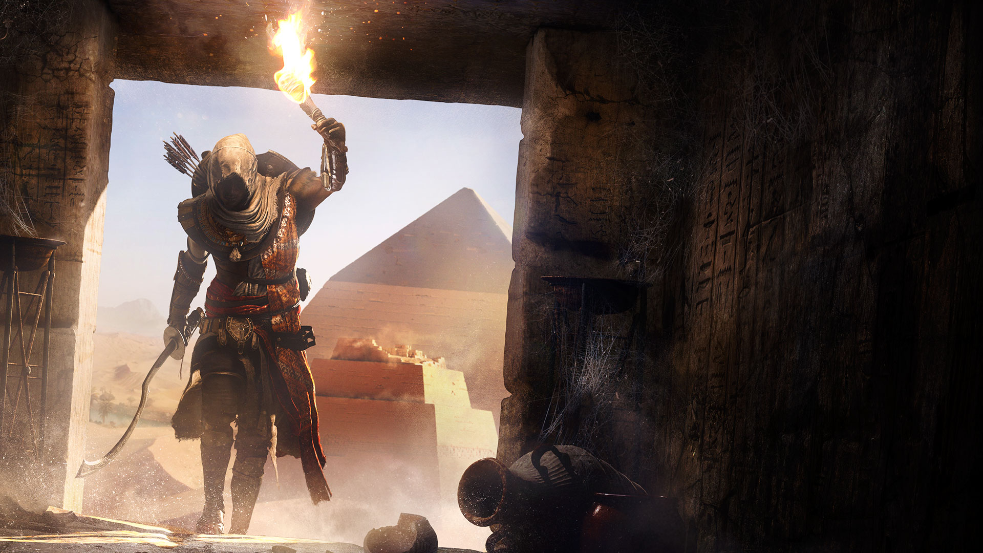 Bayek of Siwa with torch in front of pyramids HD Wallpaper