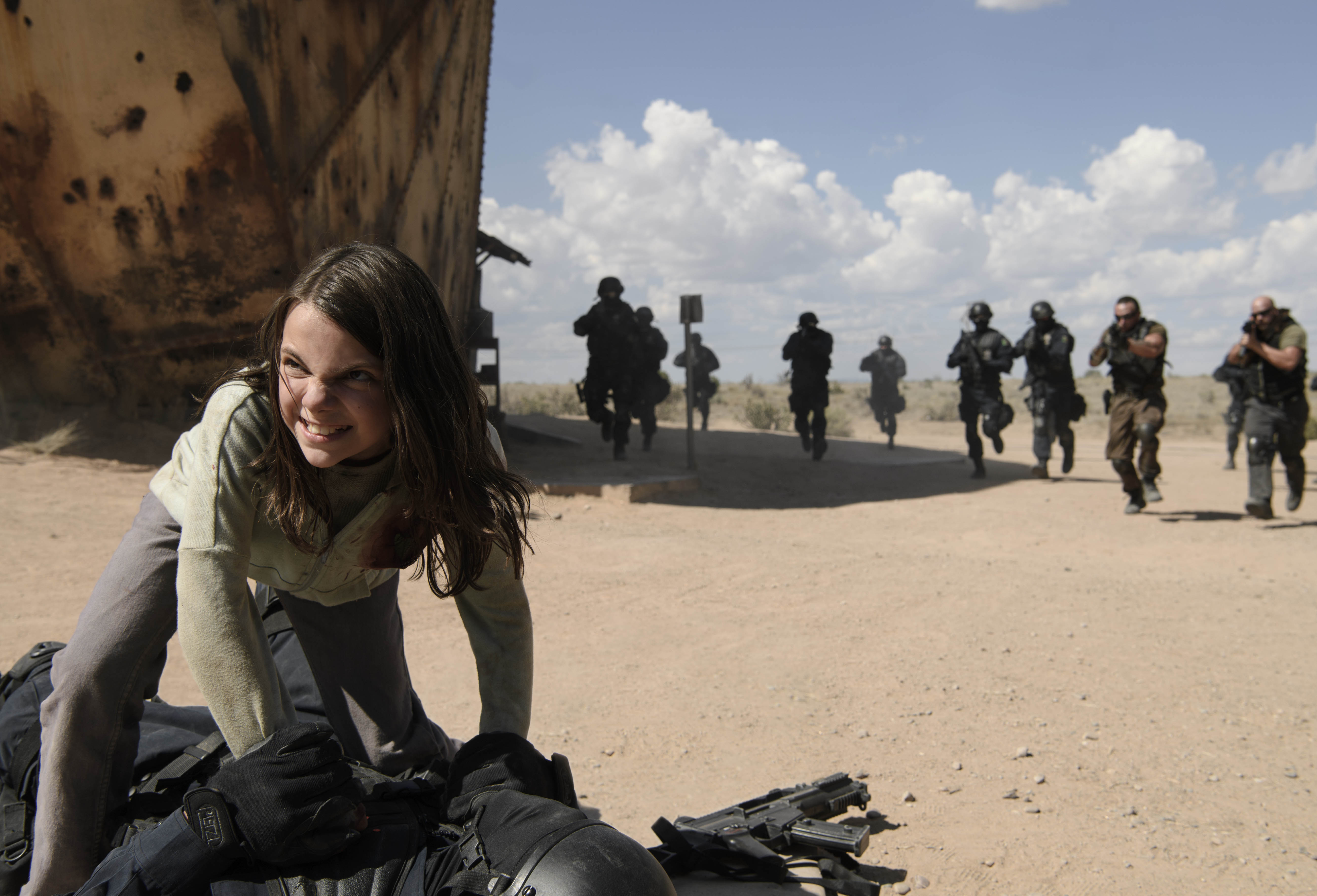 X-23 fighting soldiers in a desert HD Wallpaper