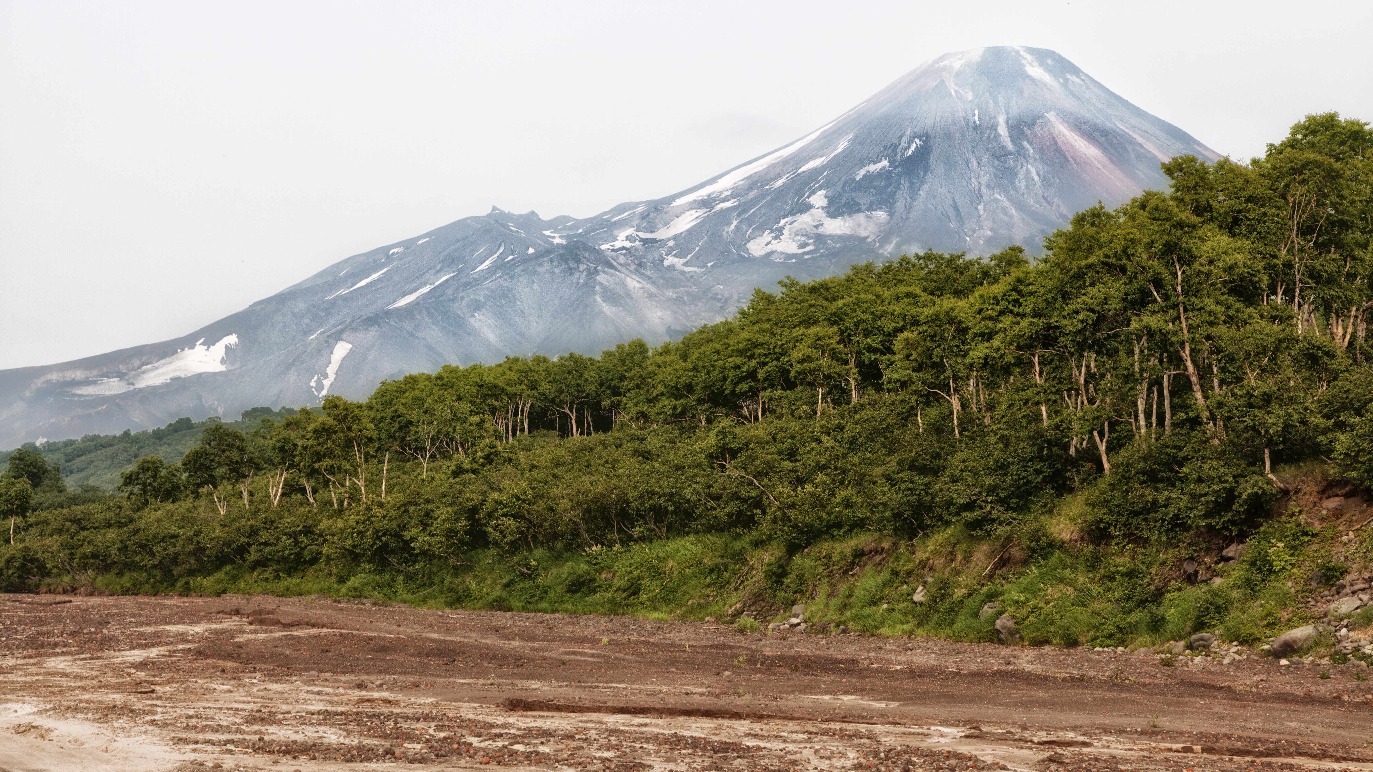 Volcano with trees and dirt foreground HD Wallpaper