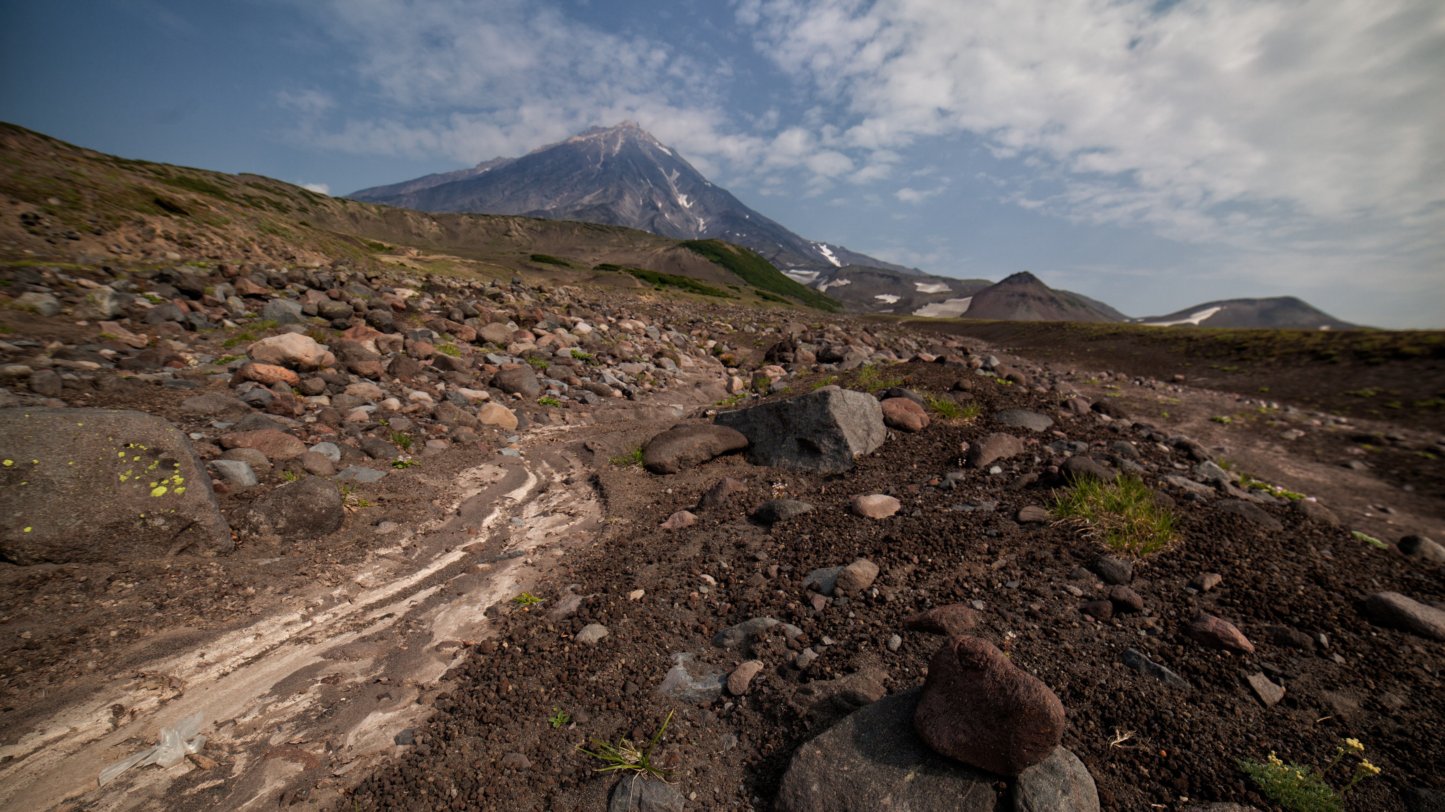 Volcano landscape with rocky terrain and clouds HD Wallpaper