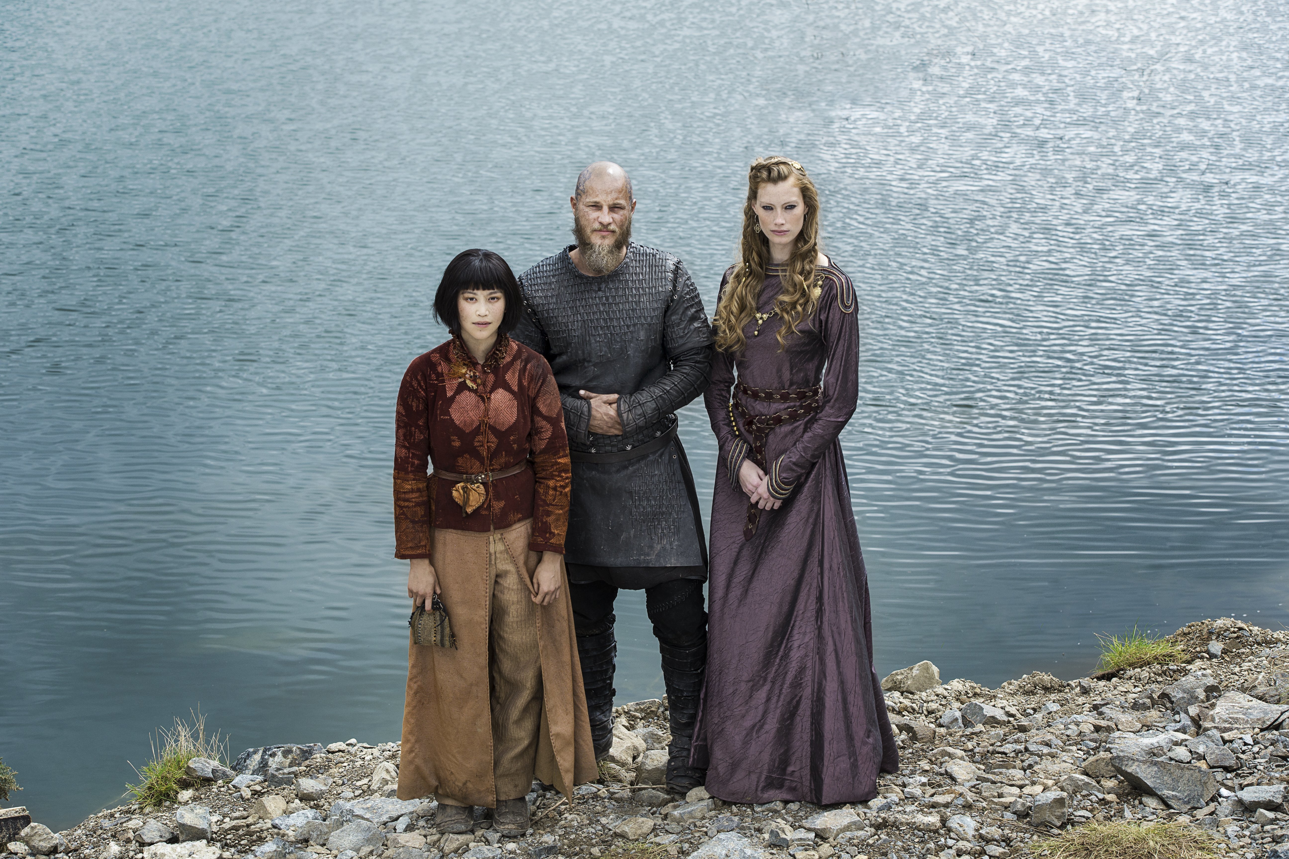 Ragnar Lothbrok with two women by a lake HD Wallpaper