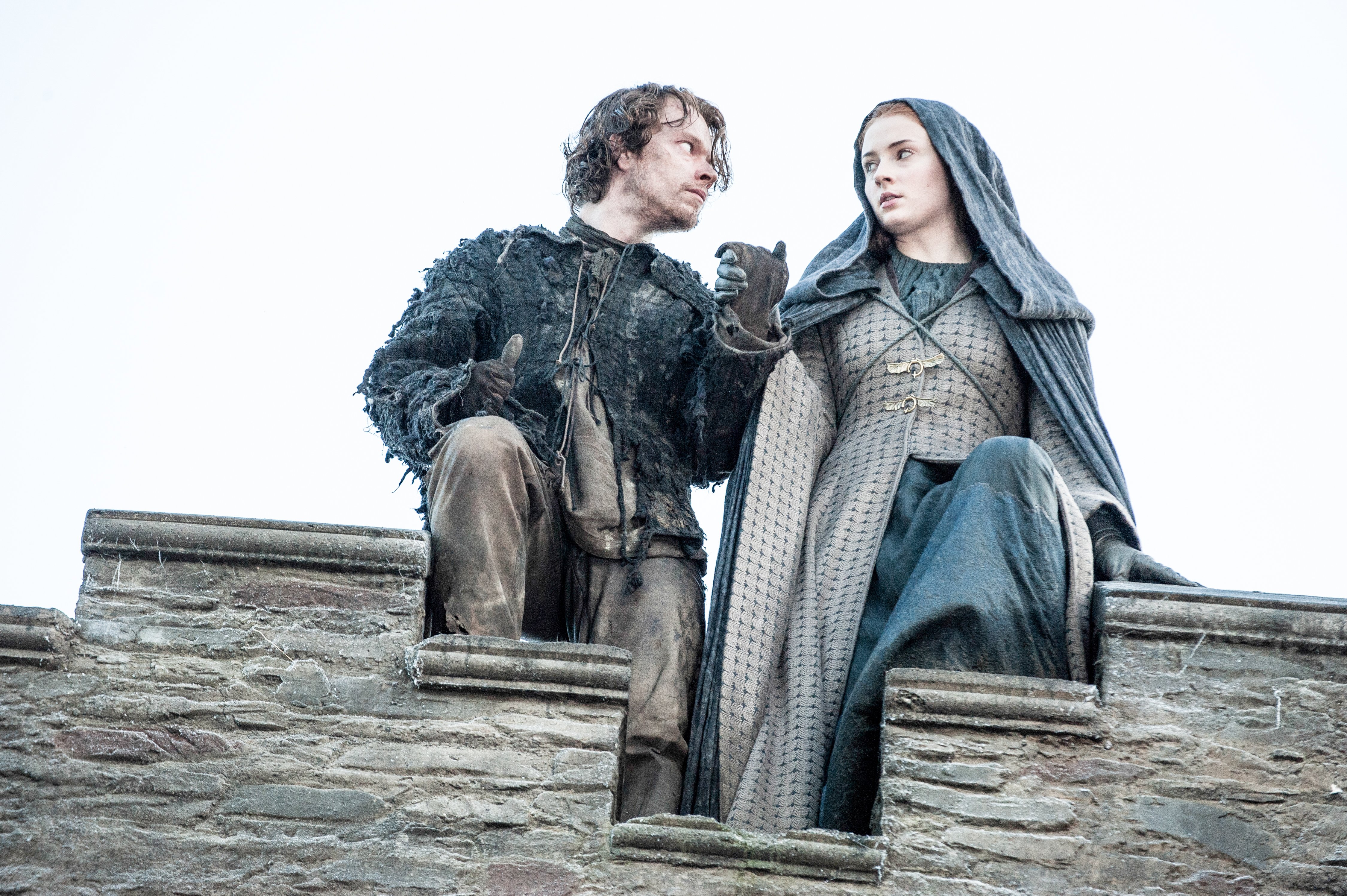 Theon Greyjoy and Sansa Stark on a castle wall HD Wallpaper