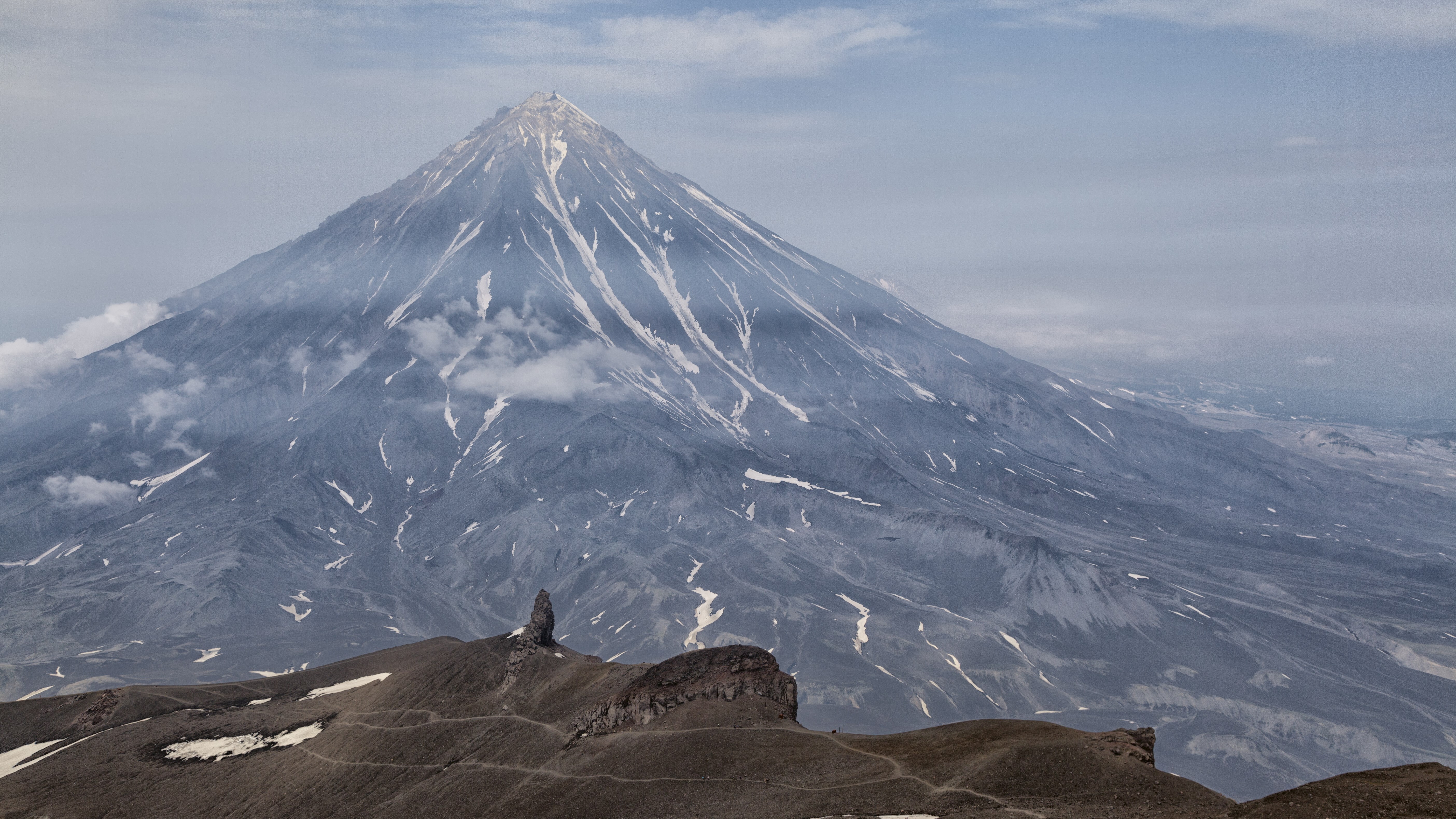 Volcano with smoke and rocky foreground HD Wallpaper
