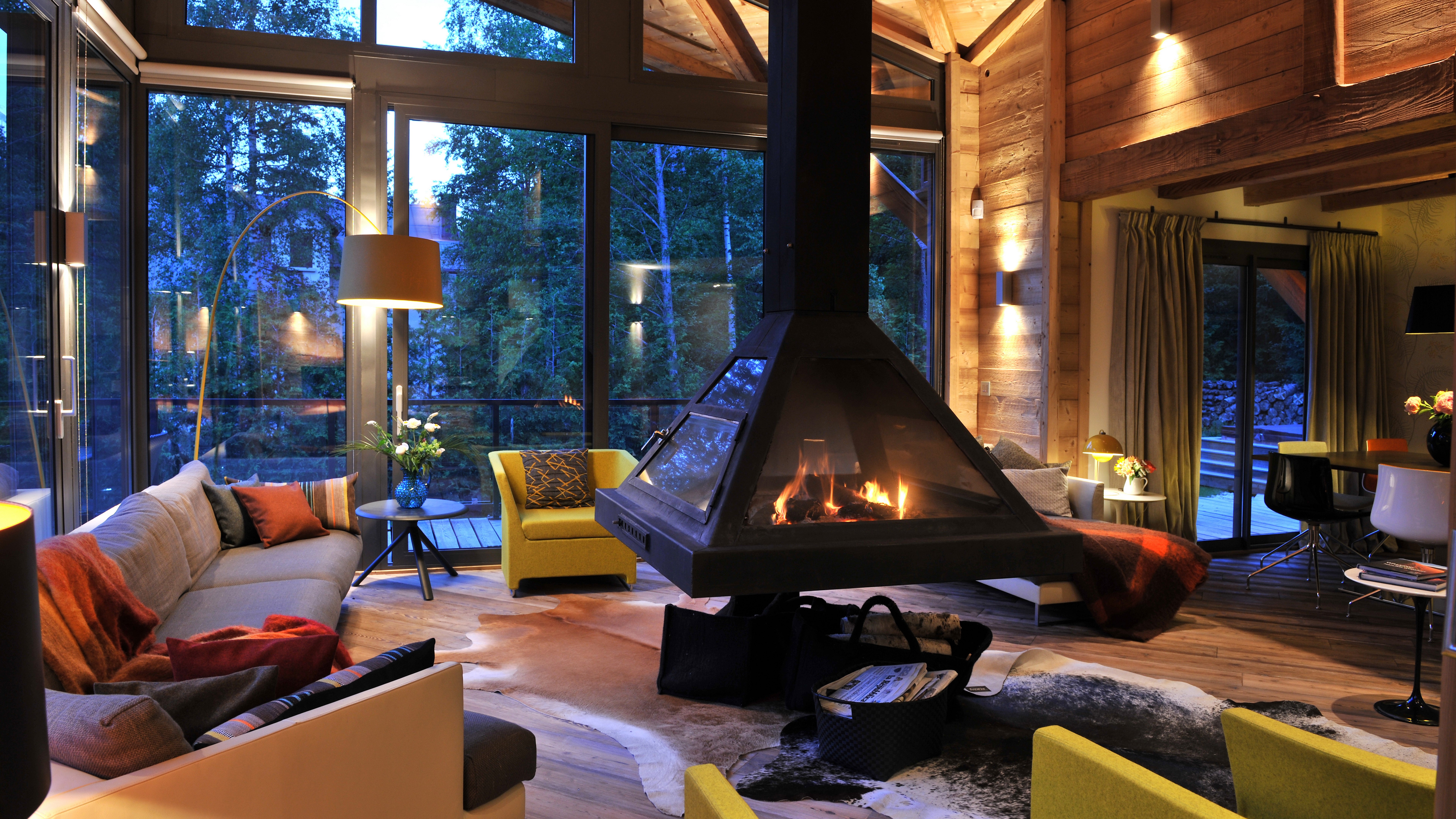 Cozy living room with fireplace and large windows HD Wallpaper