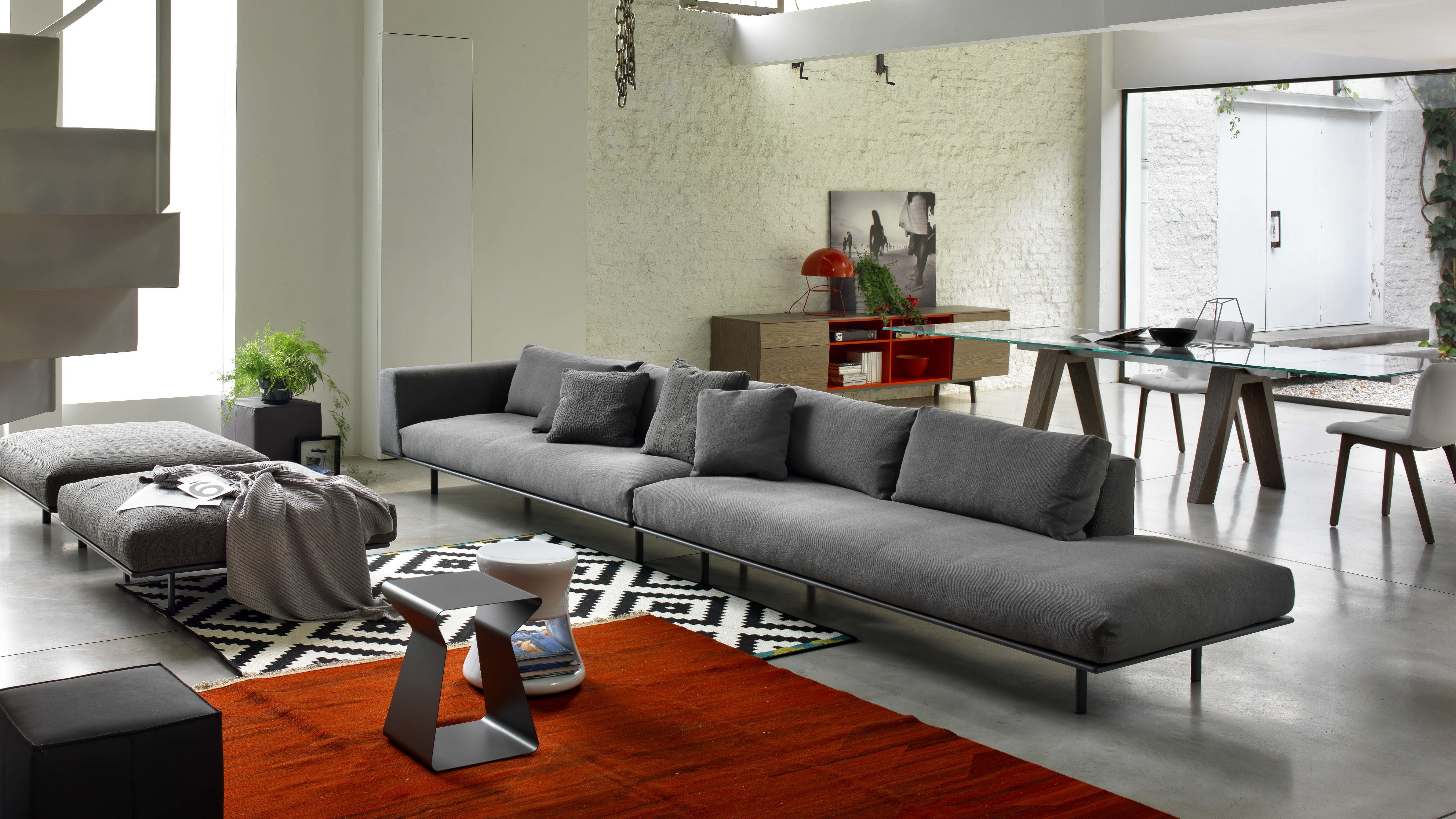 Modern living room with sectional sofa and dining table HD Wallpaper