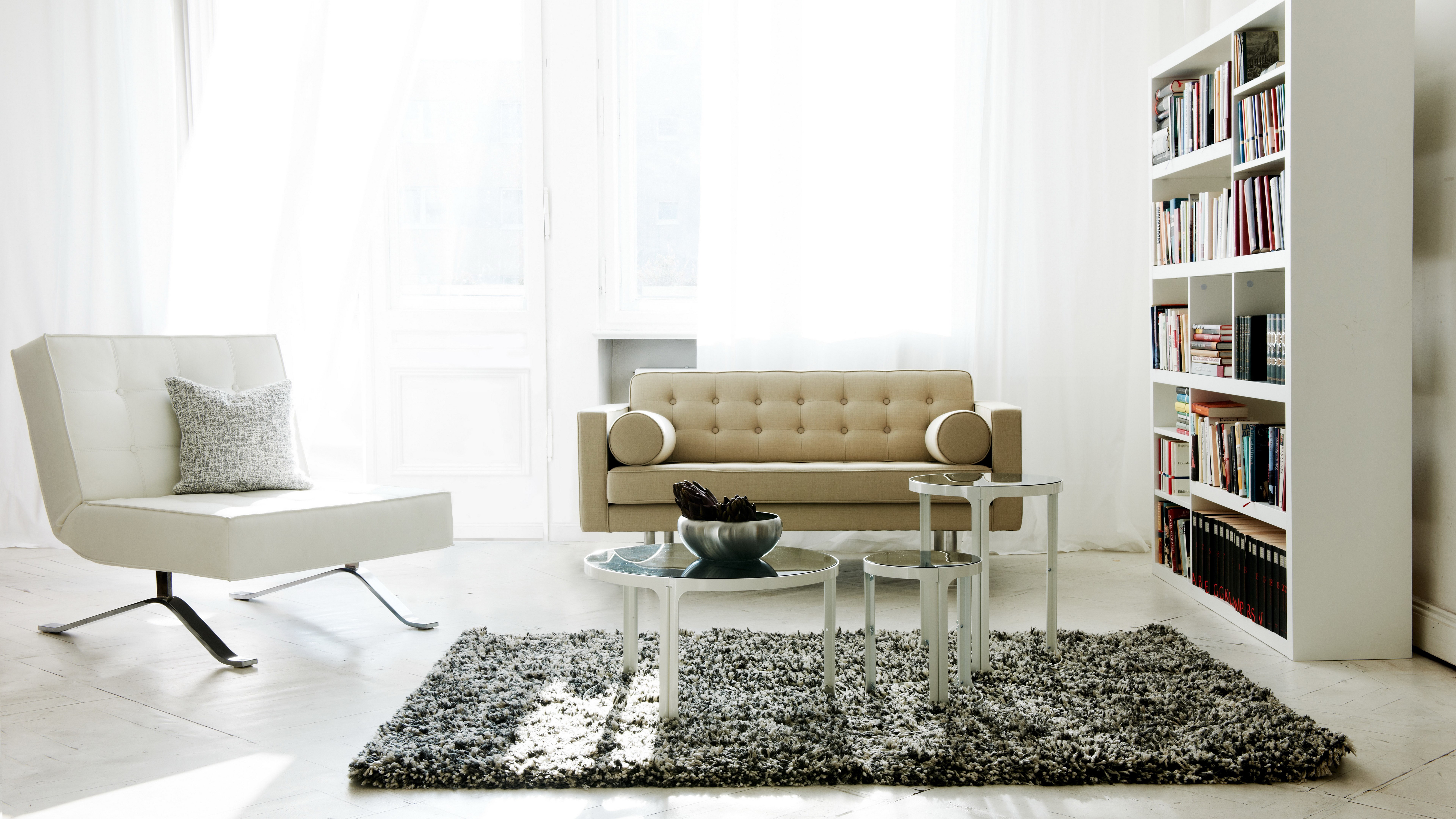 Modern living room with sofa, chair, and bookshelf HD Wallpaper