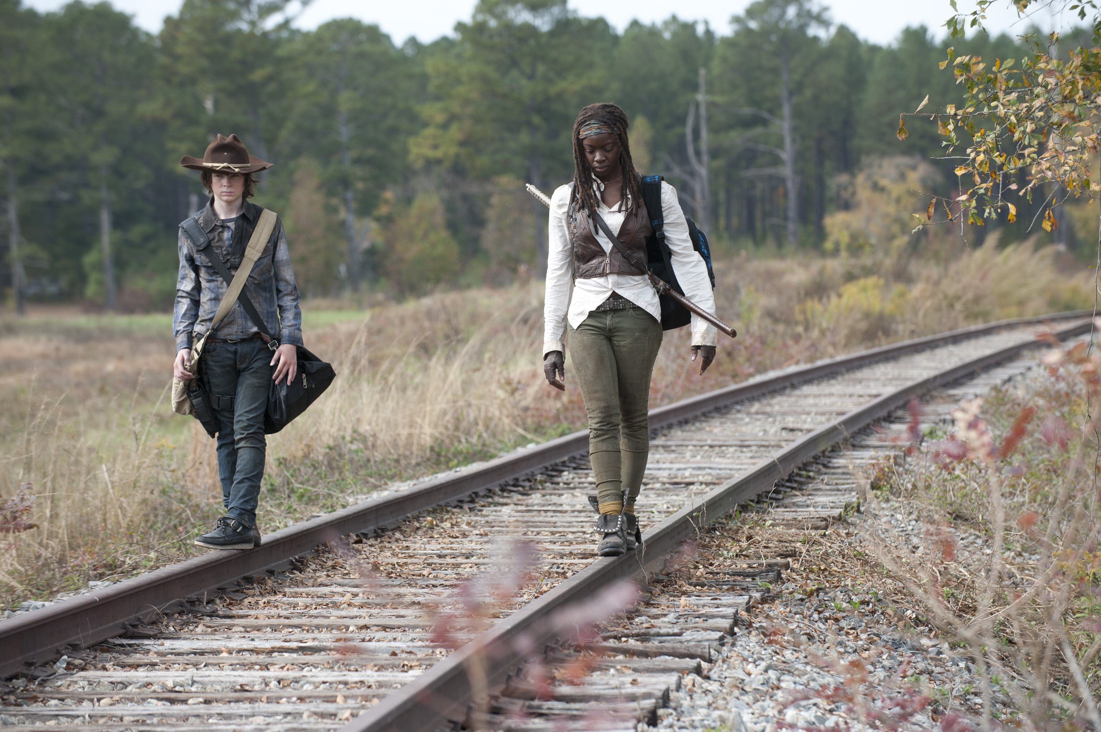 Michonne and Carl walking on train tracks HD Wallpaper