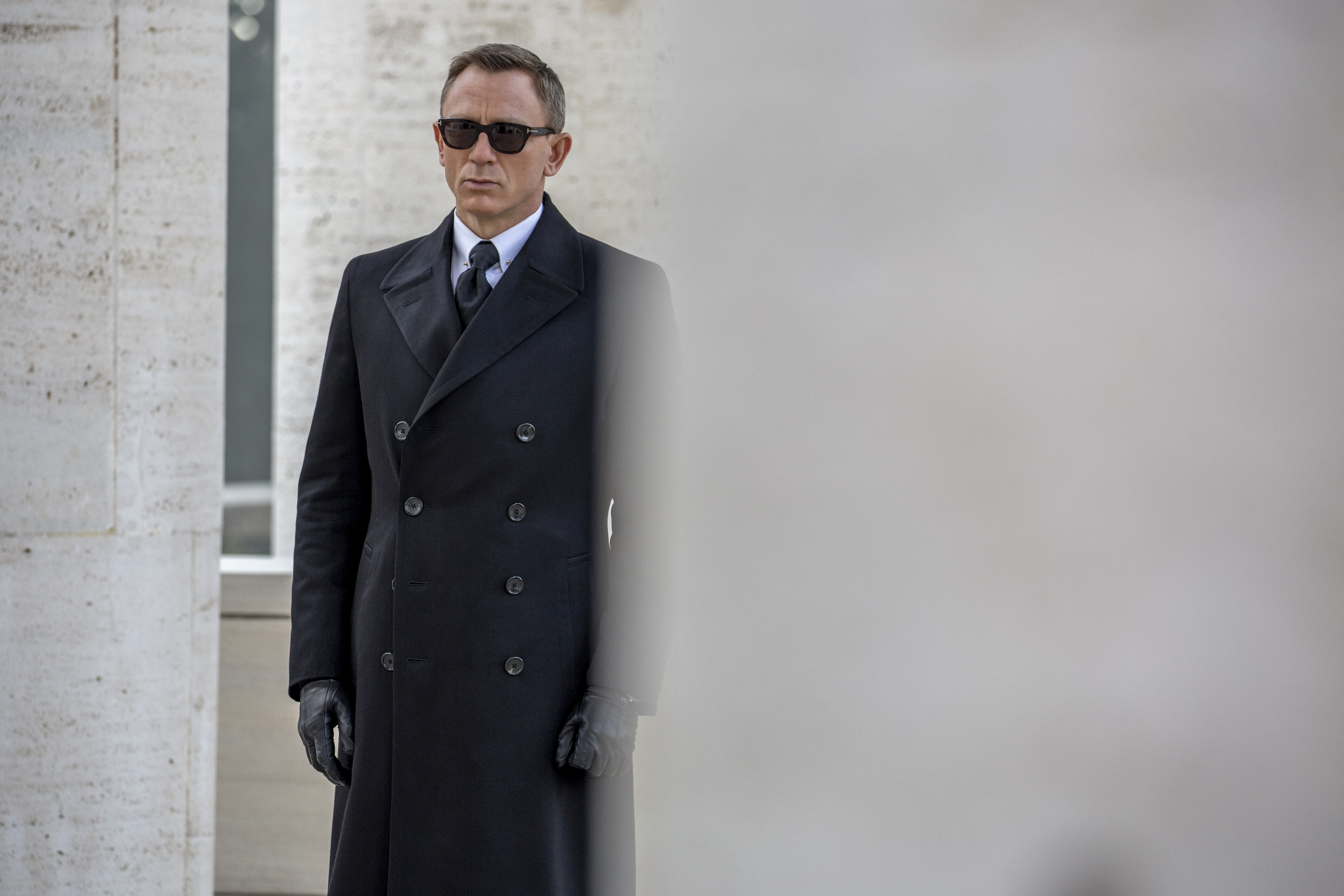 James Bond in a black coat and sunglasses HD Wallpaper