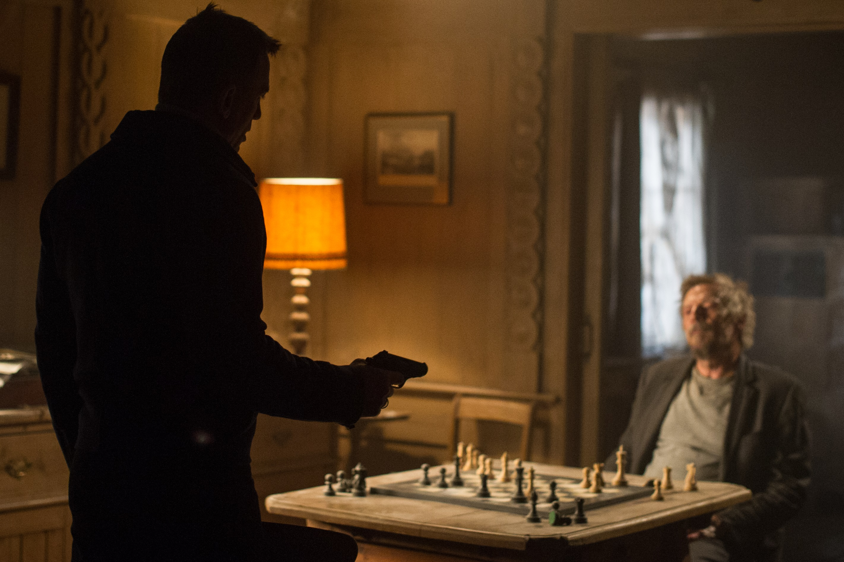 James Bond with a gun and a man playing chess HD Wallpaper