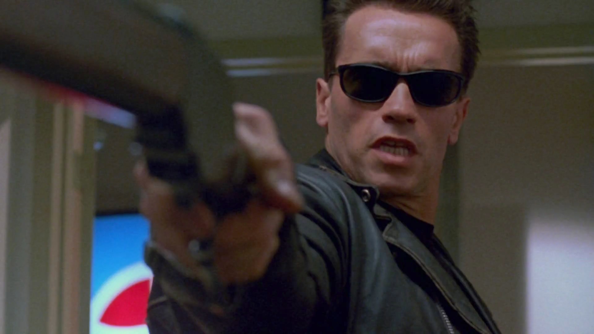 Arnold Schwarzenegger as the Terminator with a gun HD Wallpaper