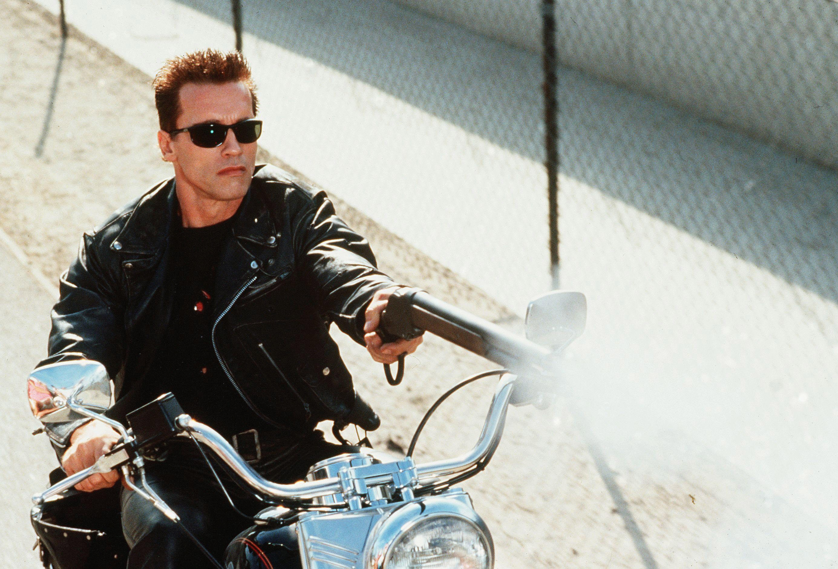 Arnold Schwarzenegger as the Terminator on a motorcycle HD Wallpaper