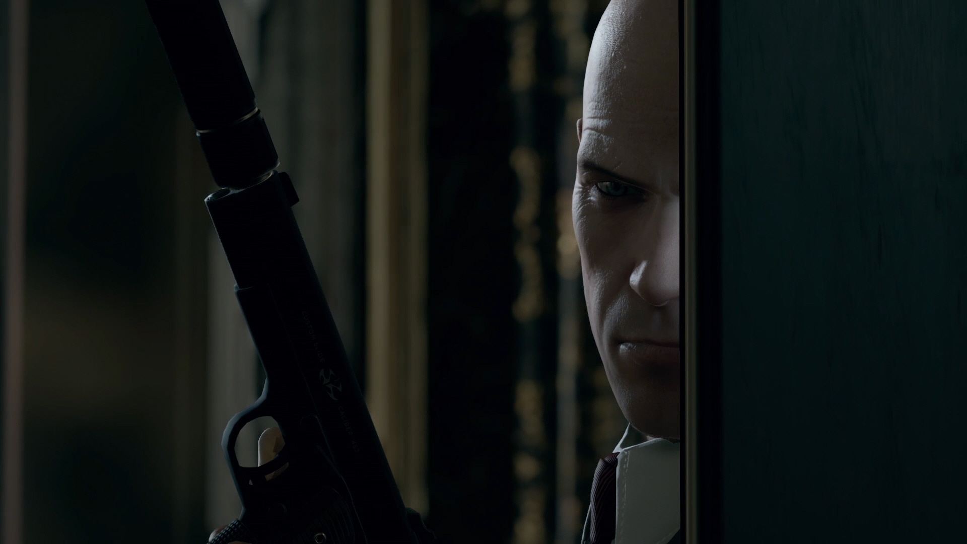 Agent 47 with a silenced pistol HD Wallpaper