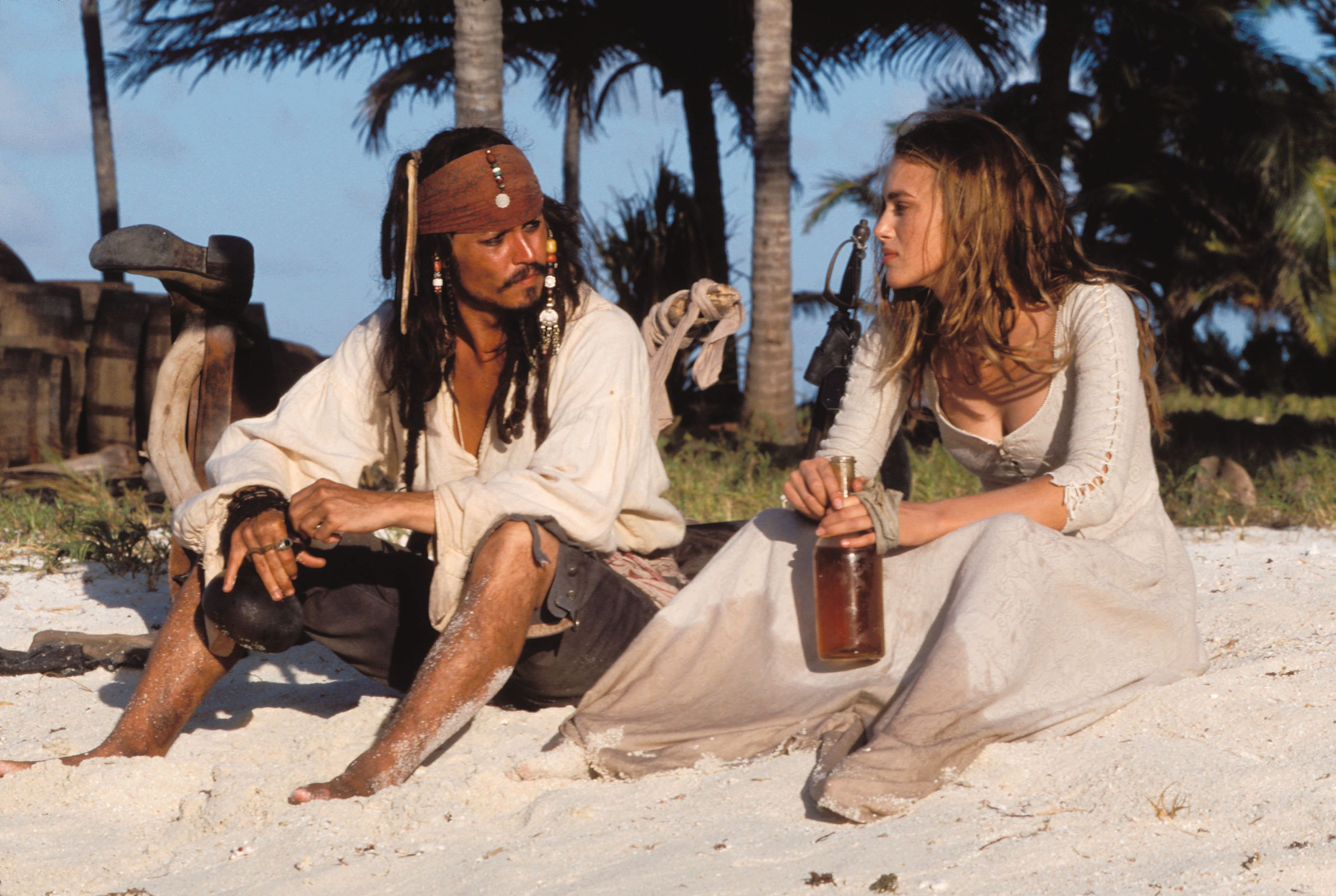 Captain Jack Sparrow and Elizabeth Swann on a beach HD Wallpaper