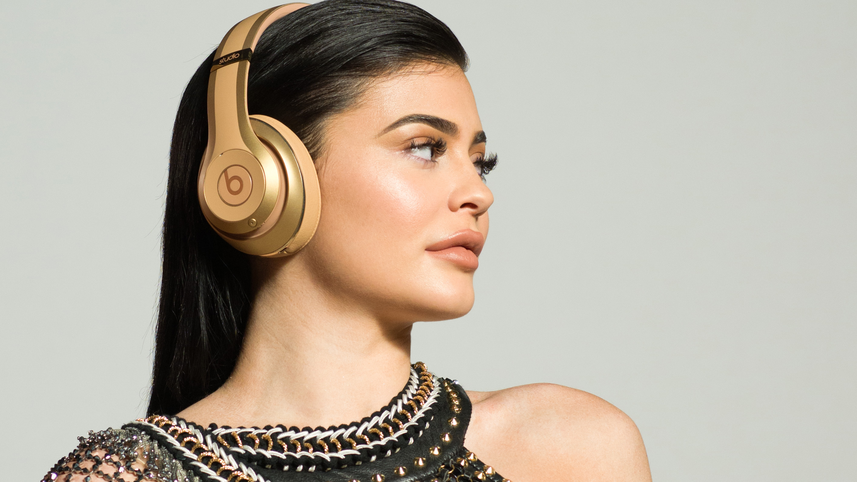 Kylie Jenner wearing gold Beats Studio headphones HD Wallpaper