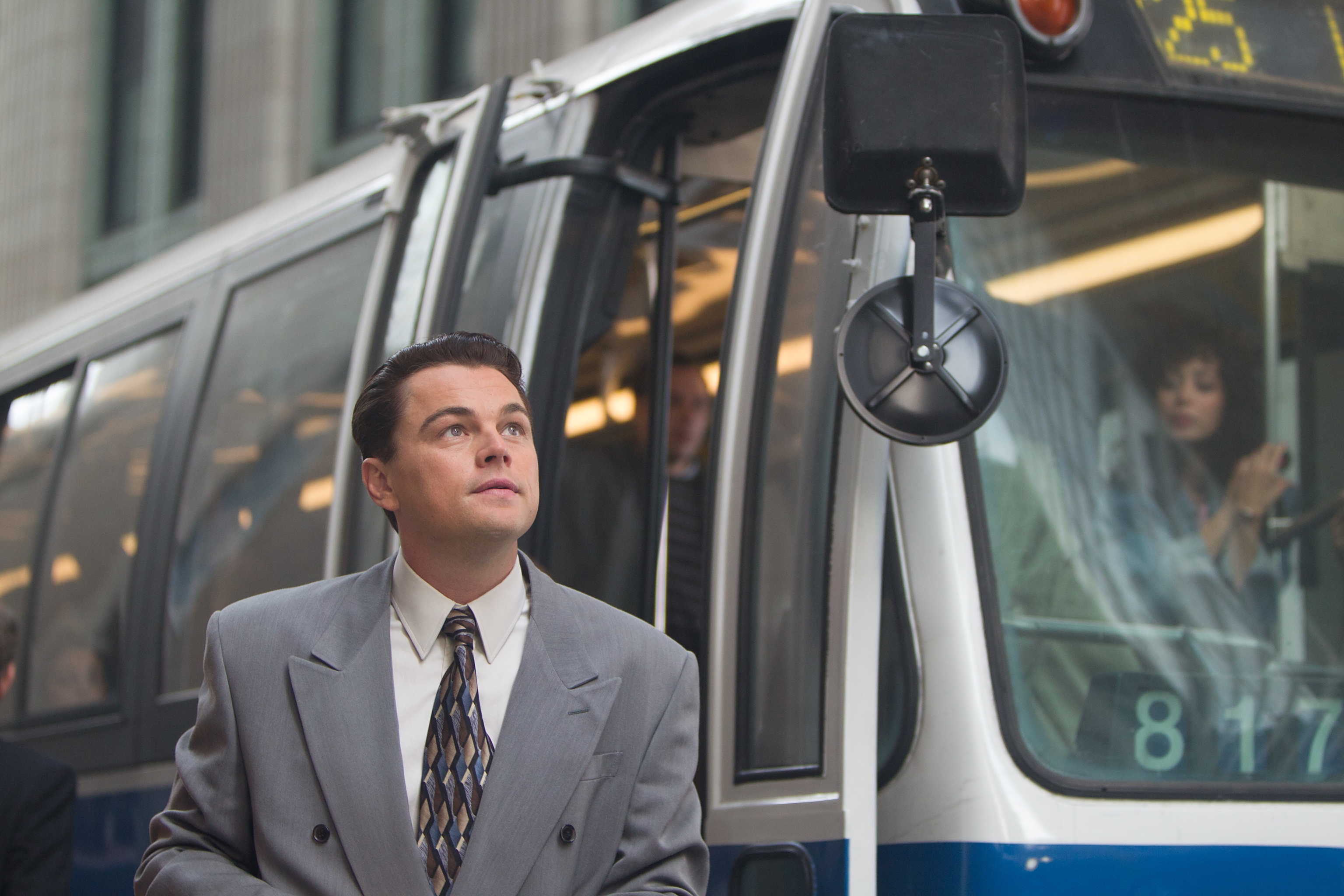 Leonardo DiCaprio as Jordan Belfort next to a bus HD Wallpaper