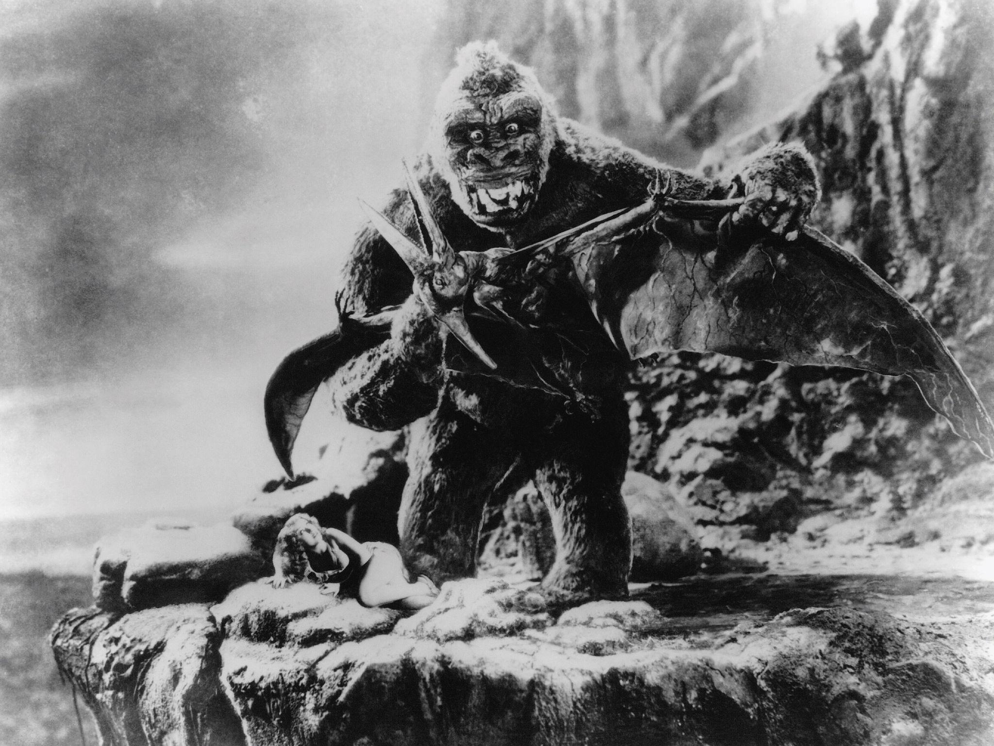 King Kong fighting a pterodactyl with a woman on a cliff HD Wallpaper