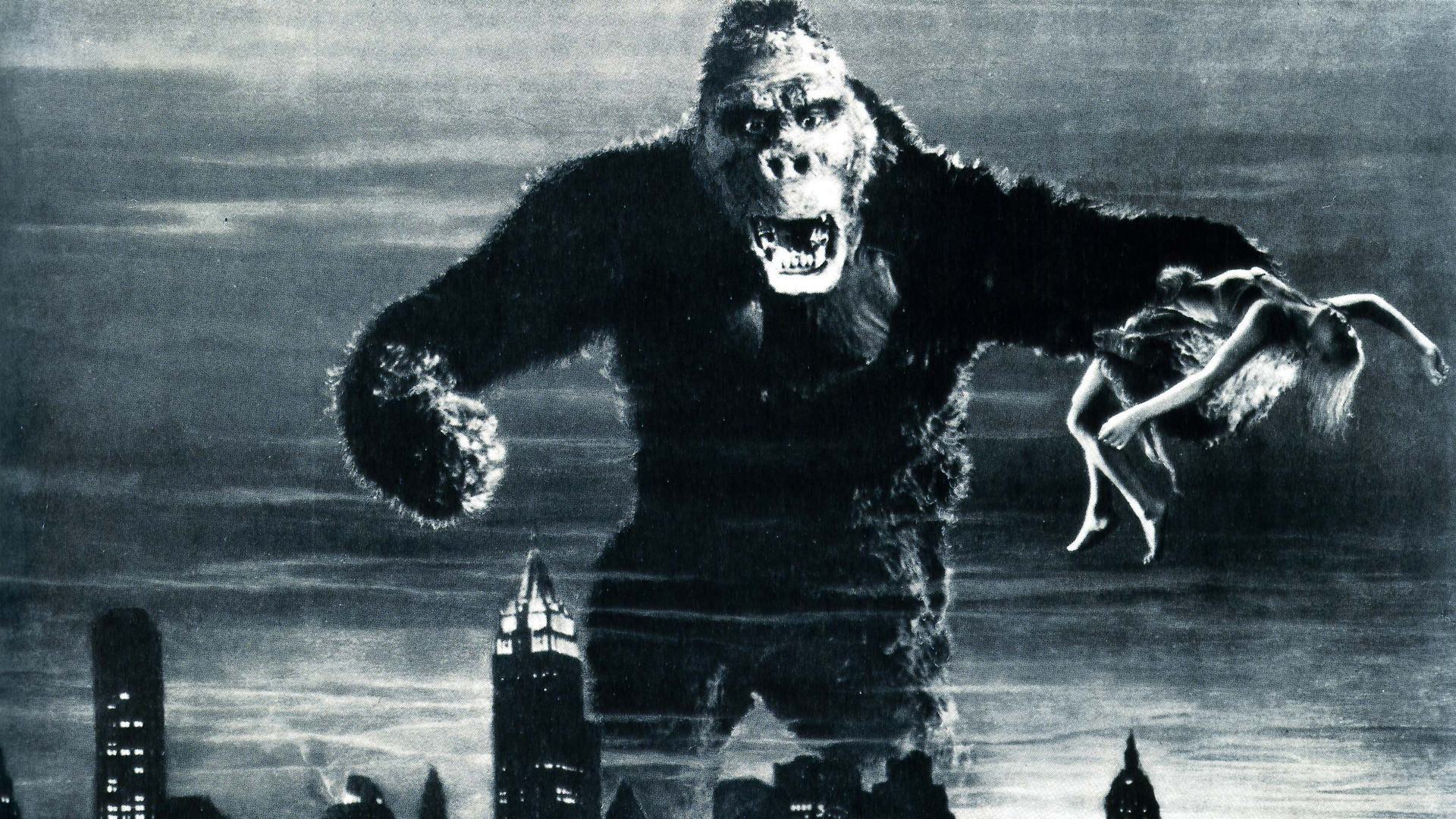 King Kong holding a woman over a city HD Wallpaper