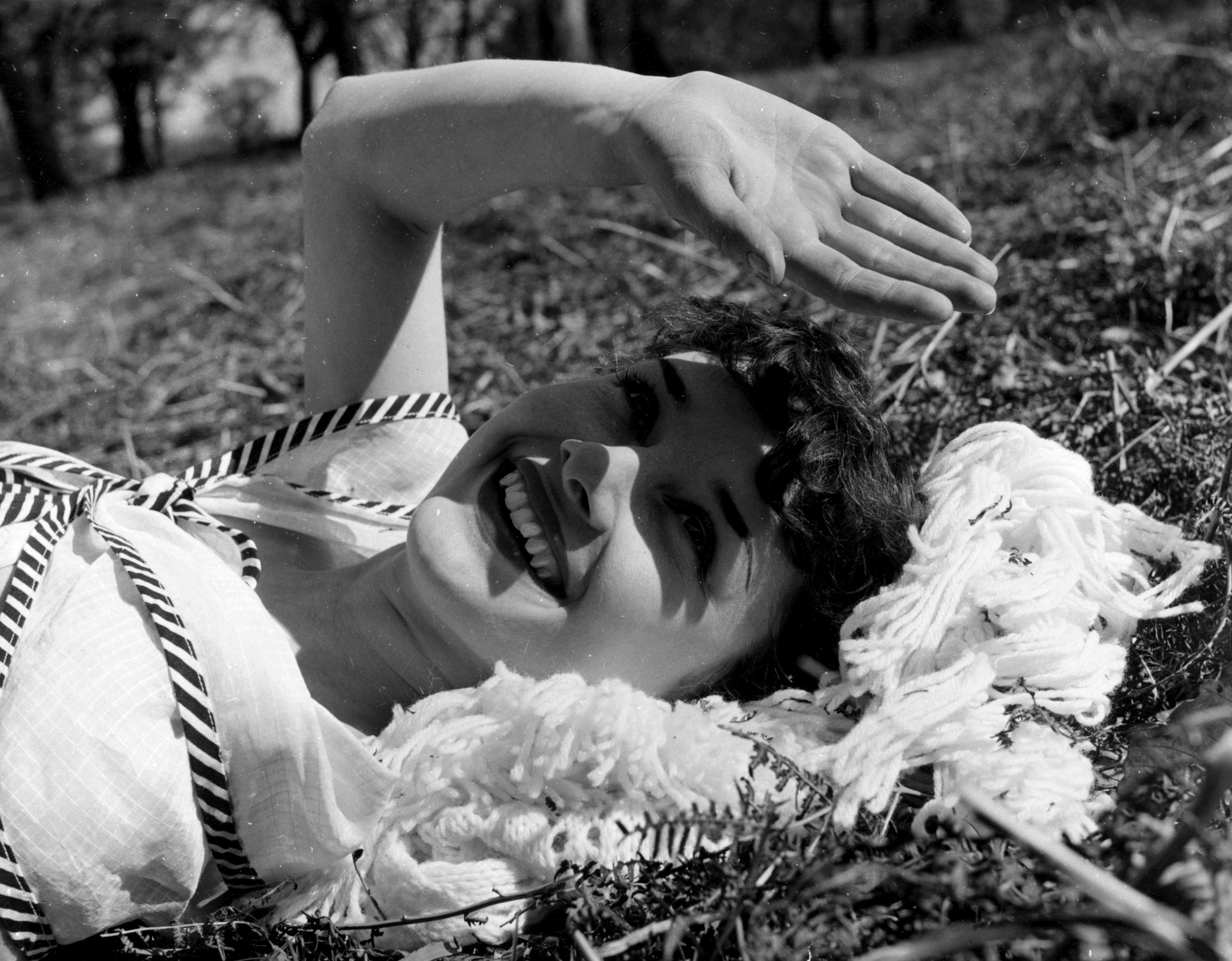 Audrey Hepburn lying in grass HD Wallpaper