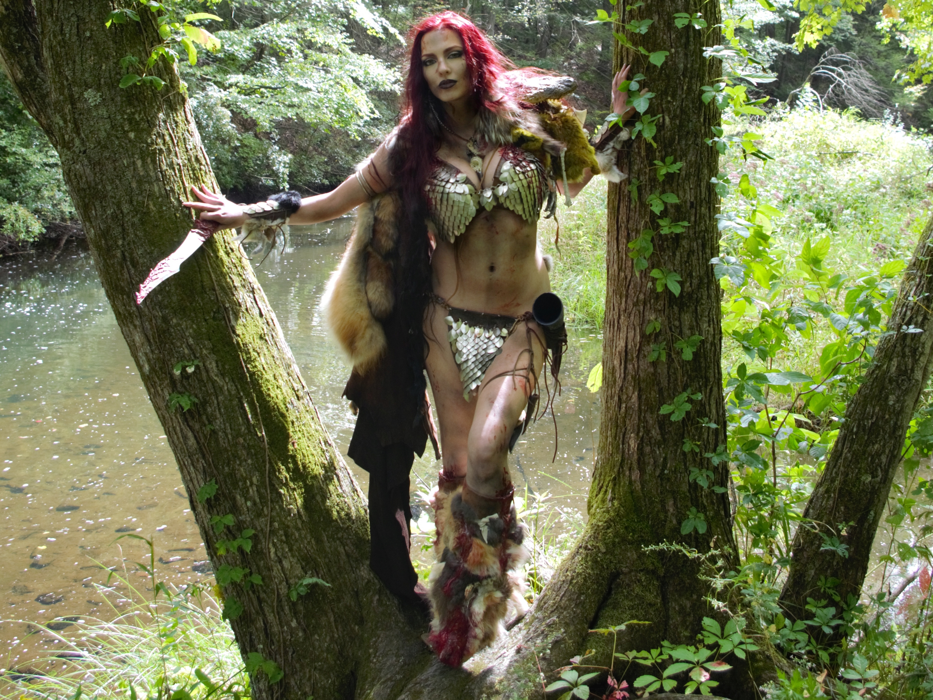 Red Sonja in a forest by a stream HD Wallpaper