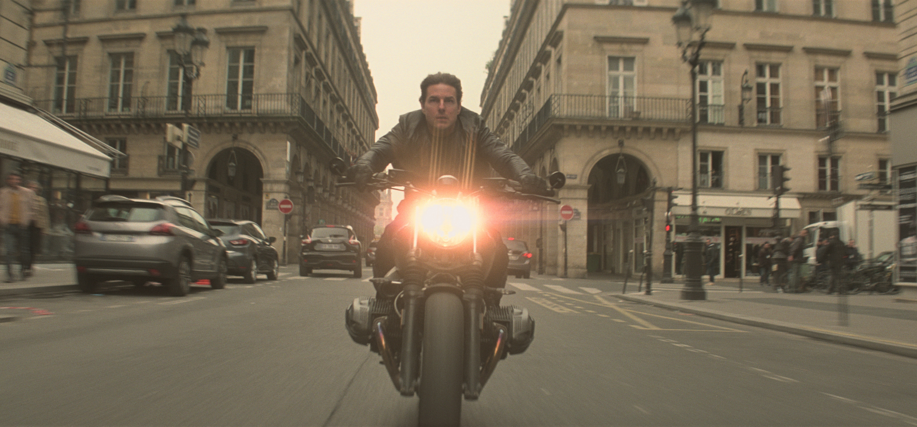Ethan Hunt riding a motorcycle in Paris HD Wallpaper