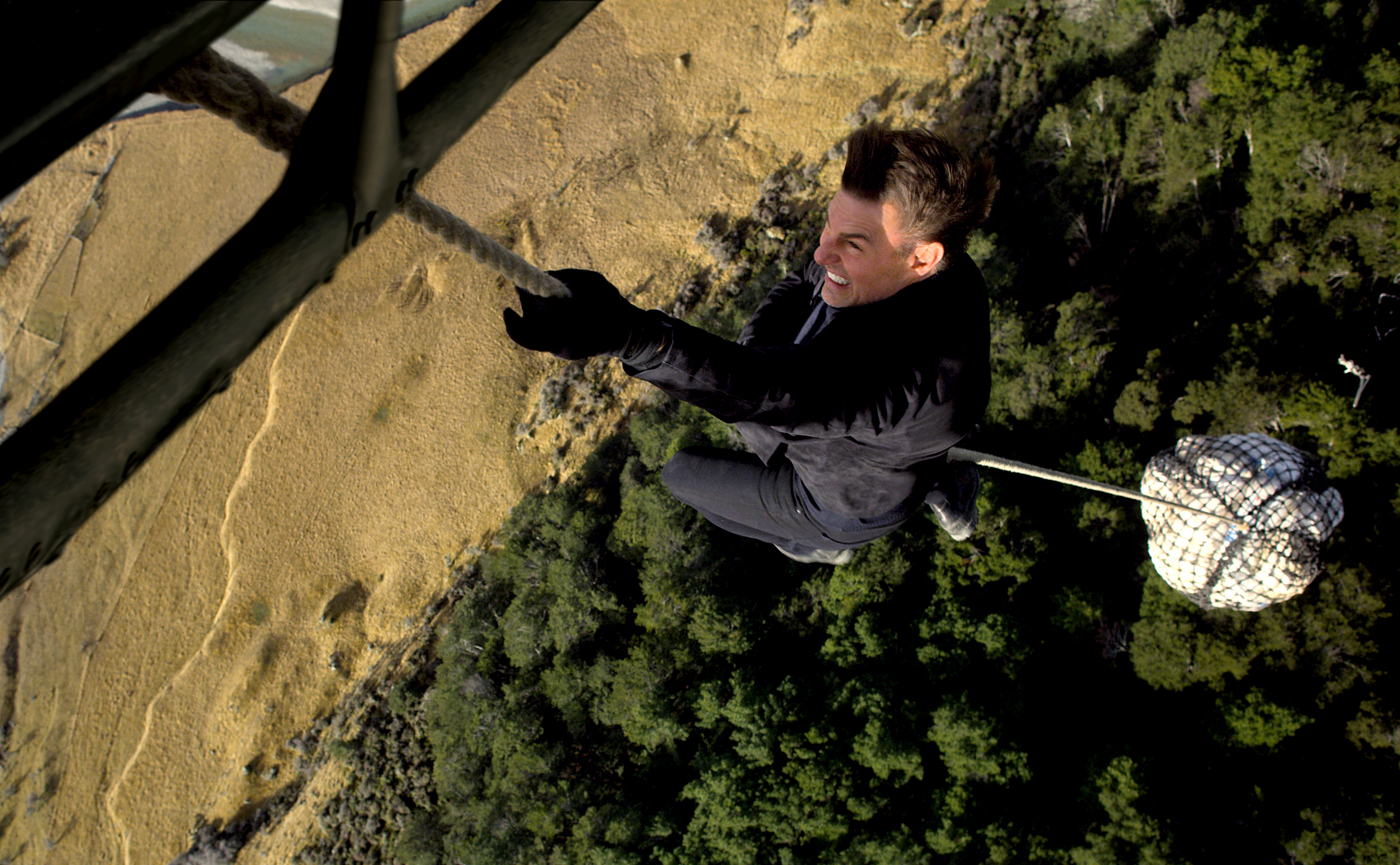 Ethan Hunt hanging from a rope HD Wallpaper