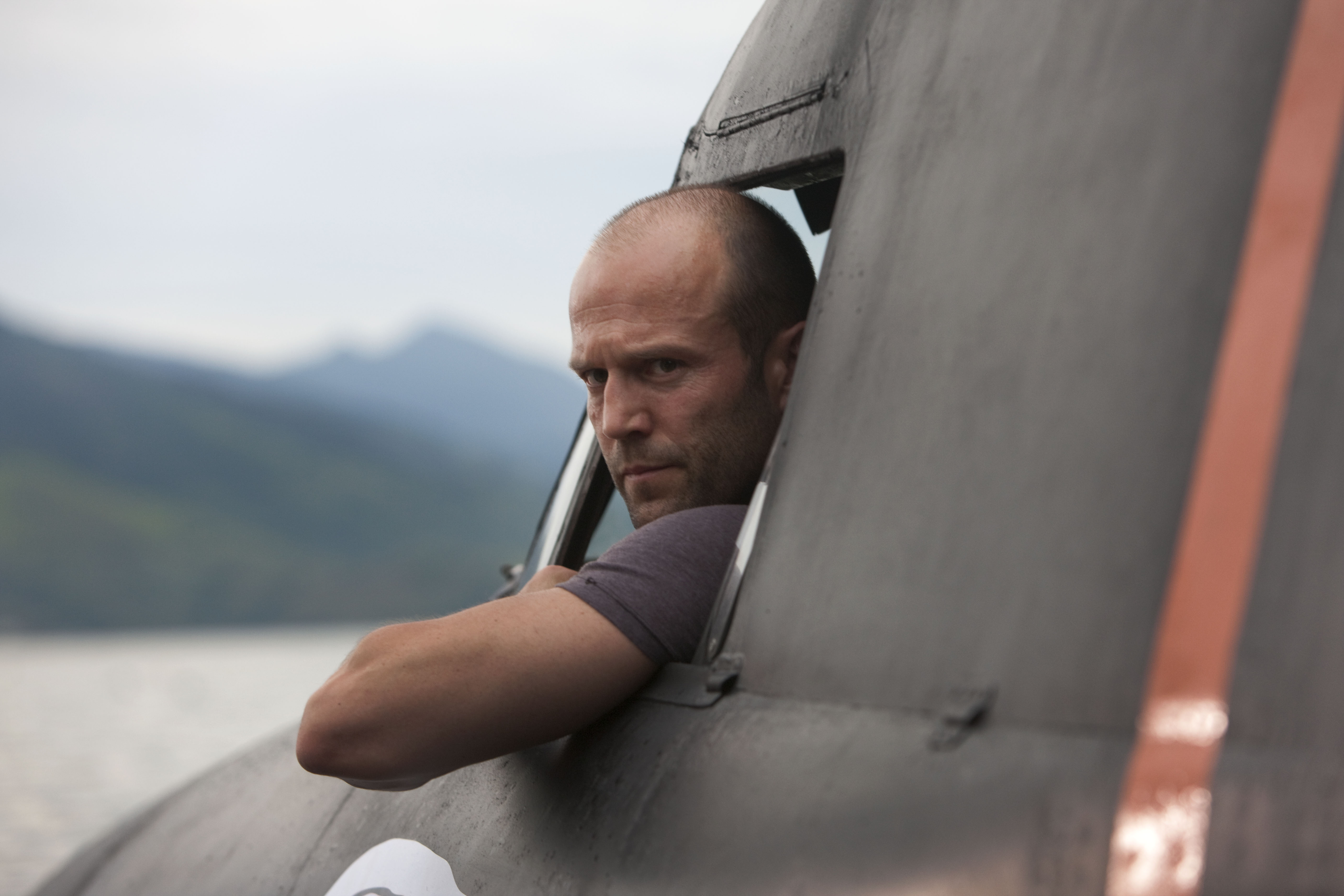 Jason Statham in a vehicle HD Wallpaper