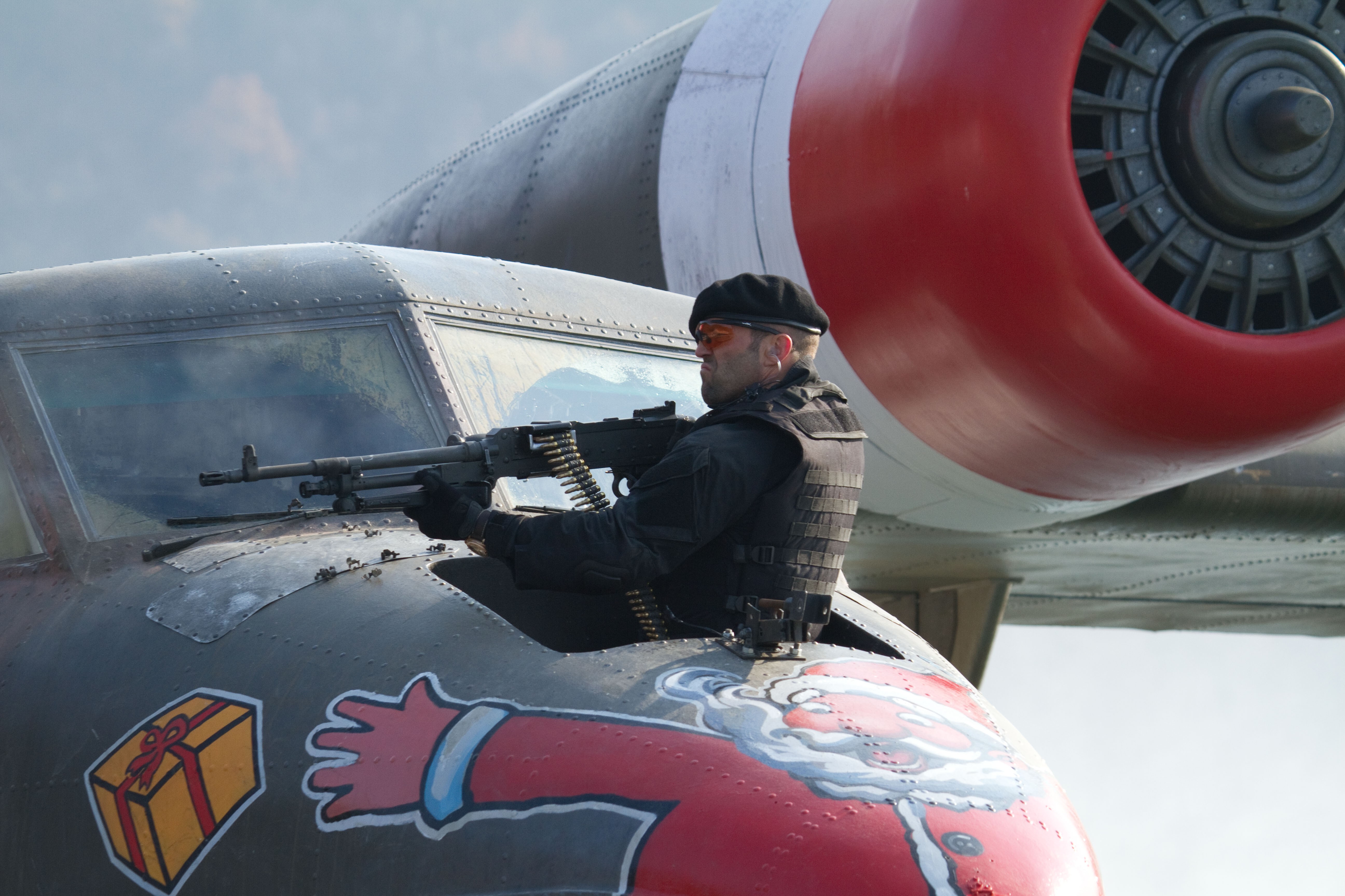 Man with machine gun on airplane with Santa painting HD Wallpaper