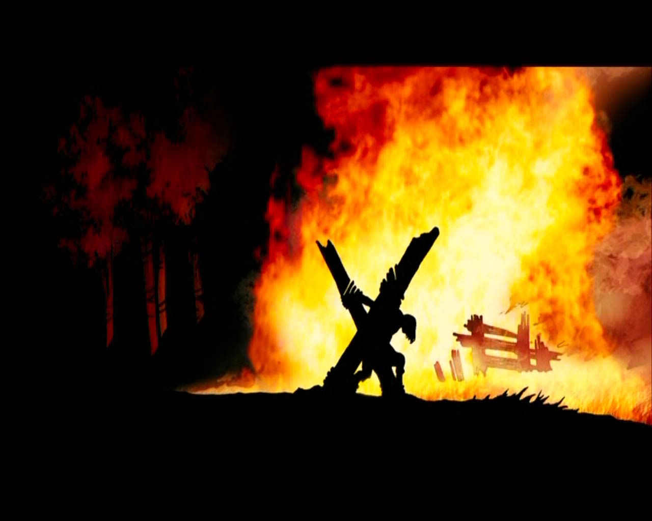 Jonah Hex carrying the cross in front of a fire HD Wallpaper