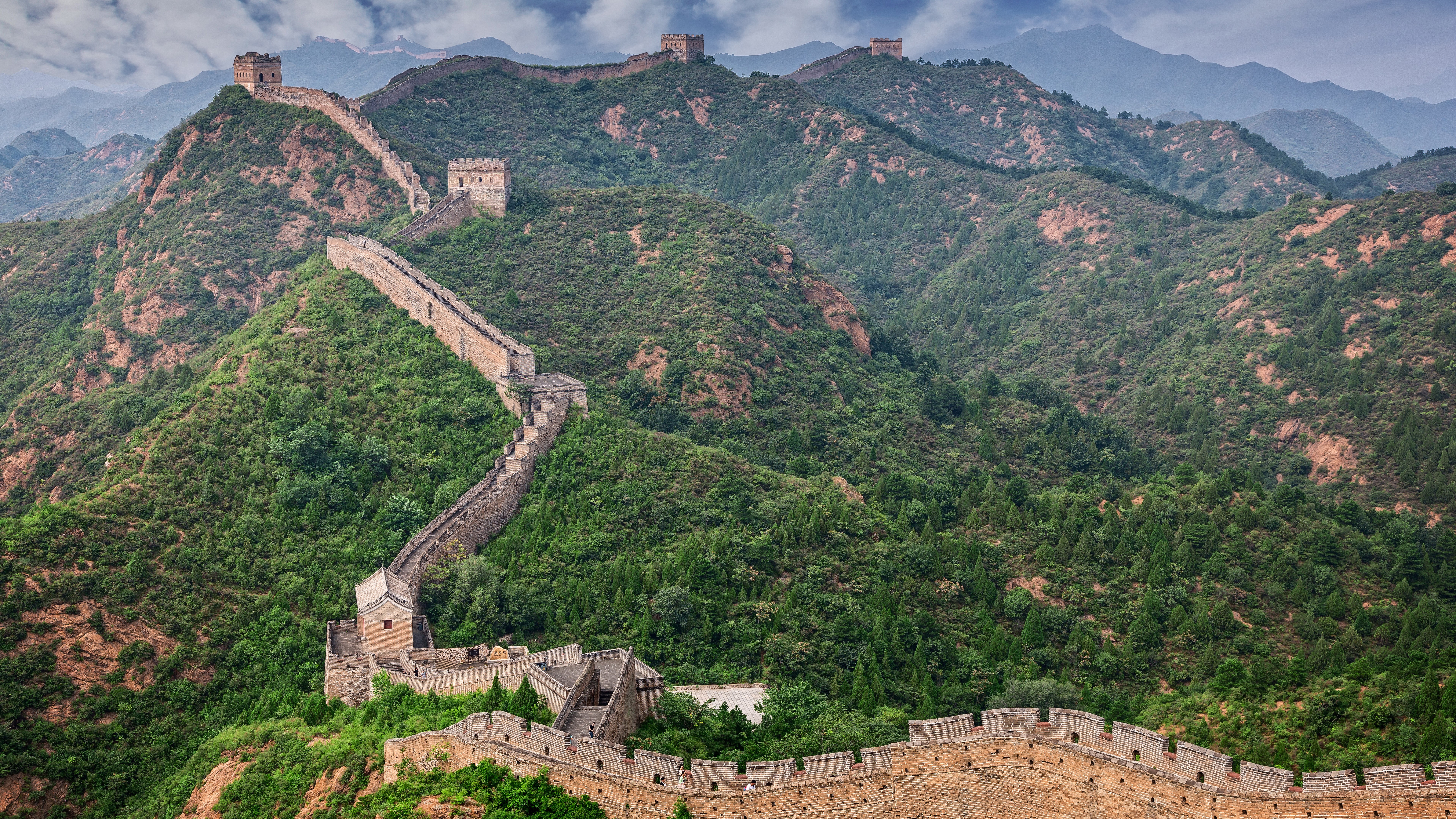 The Great Wall of China winding through green mountains HD Wallpaper