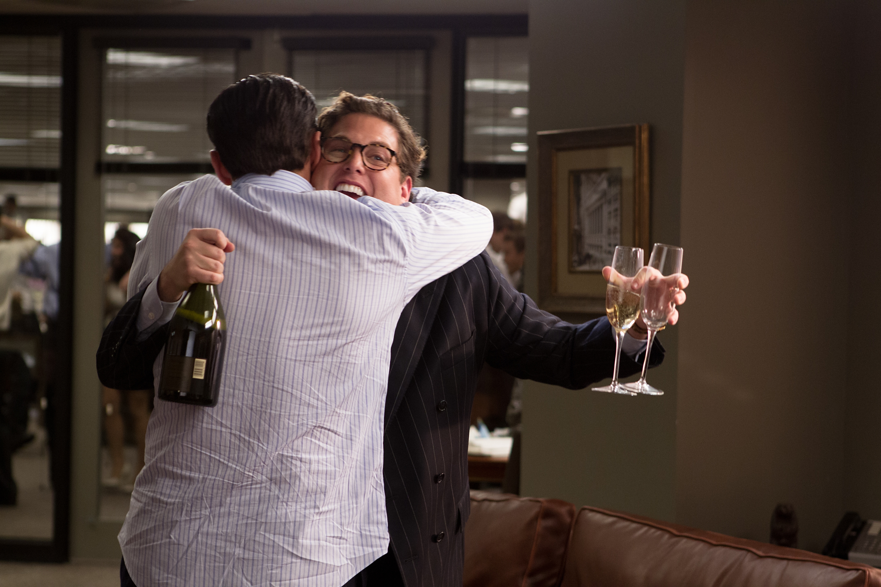 Jonah Hill hugging a man holding champagne HD Wallpaper
