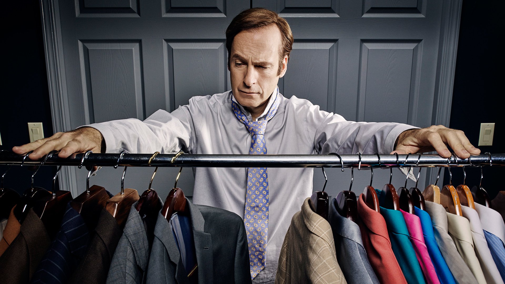 Jimmy McGill in front of a closet with suits HD Wallpaper