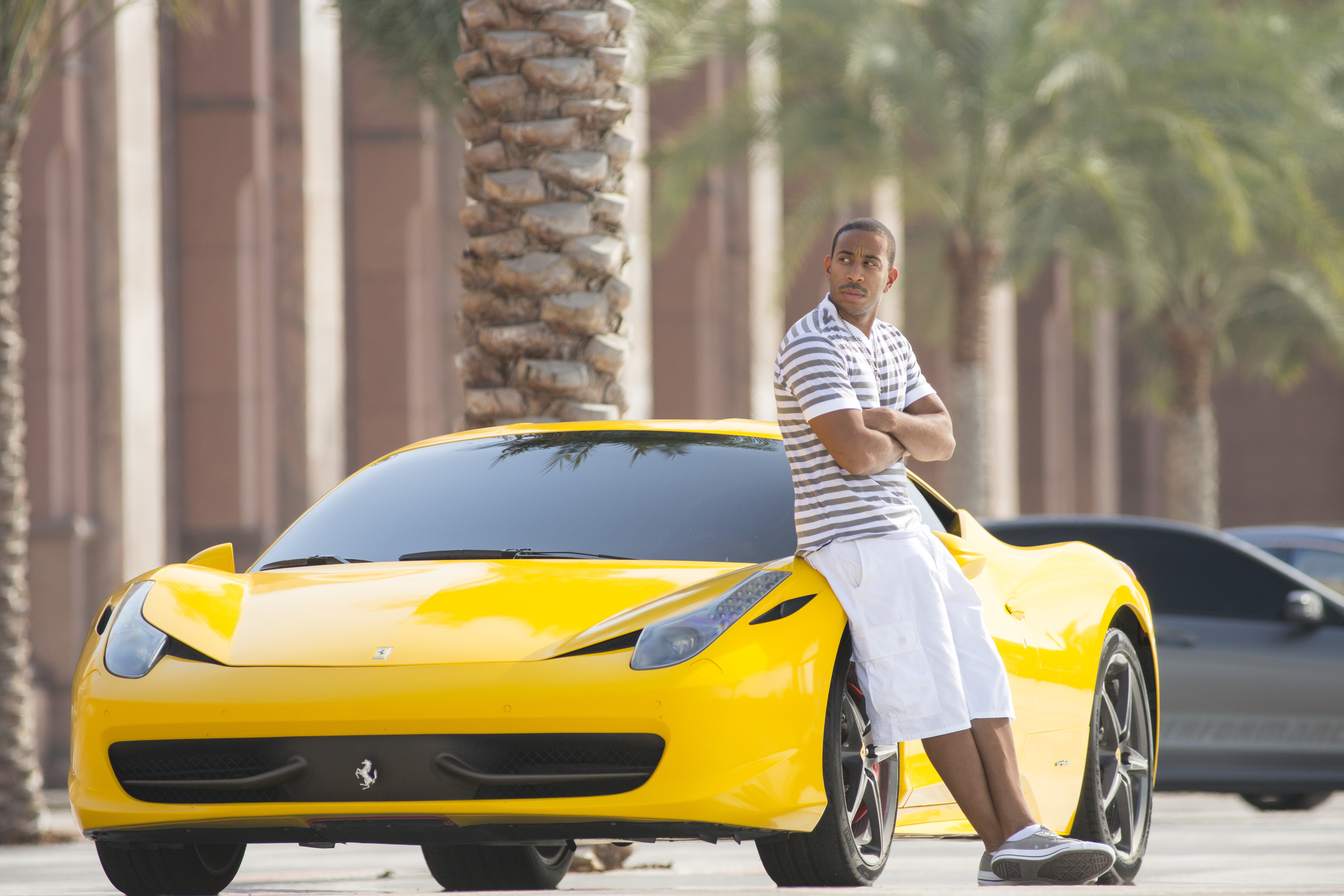 Man leaning on a yellow Ferrari HD Wallpaper