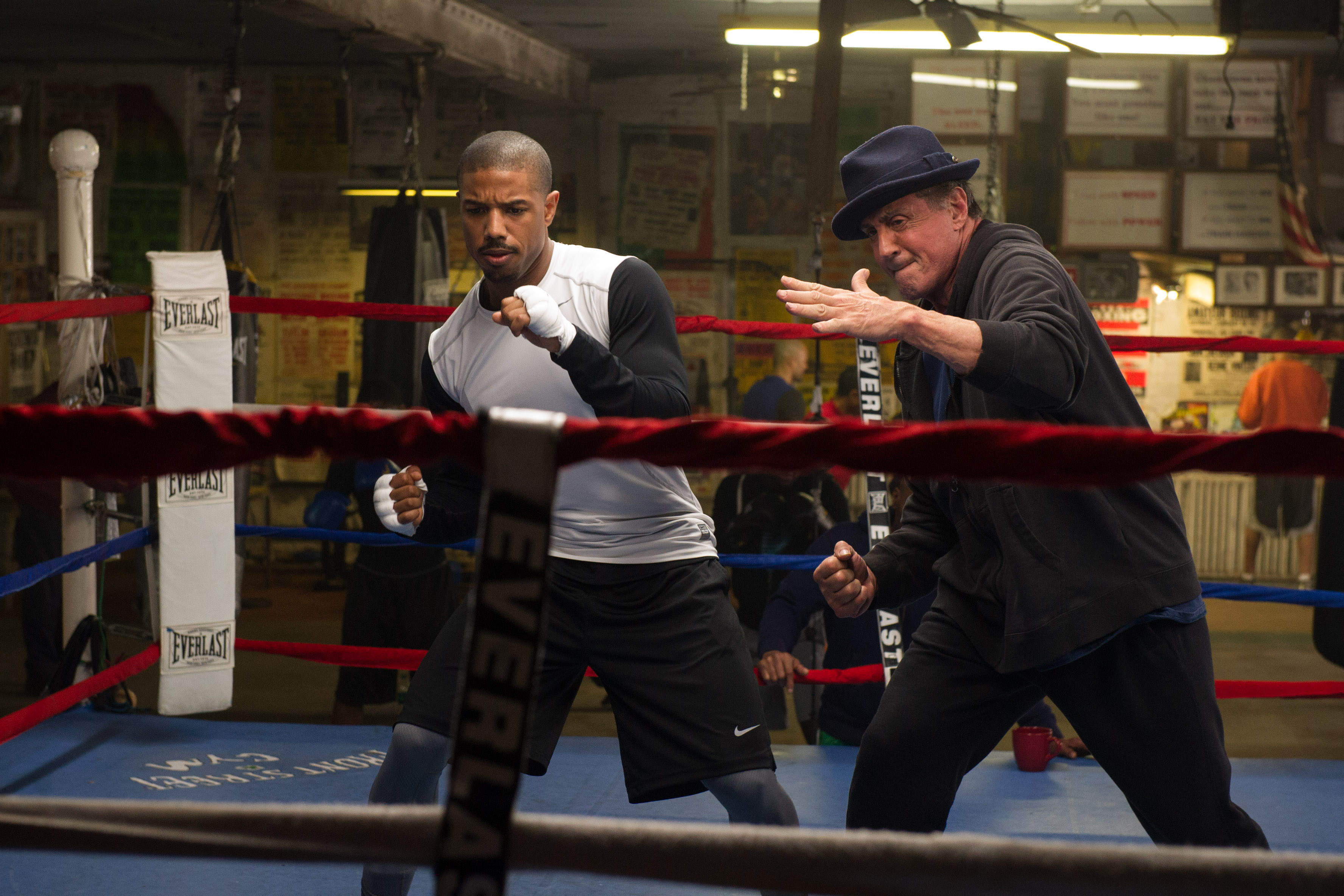 Michael B. Jordan and Sylvester Stallone in a boxing ring HD Wallpaper