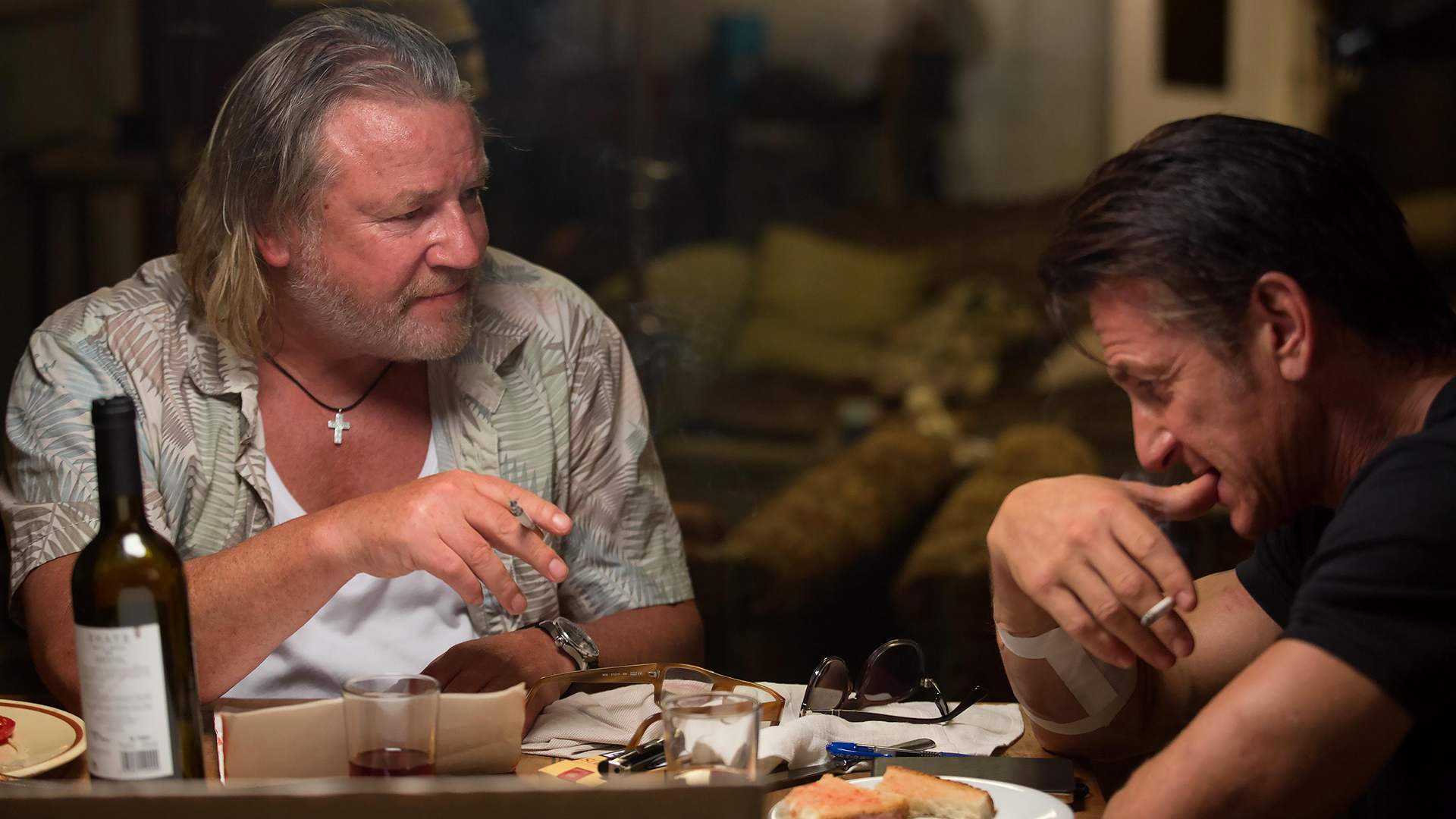 Sean Penn and another man at a table HD Wallpaper