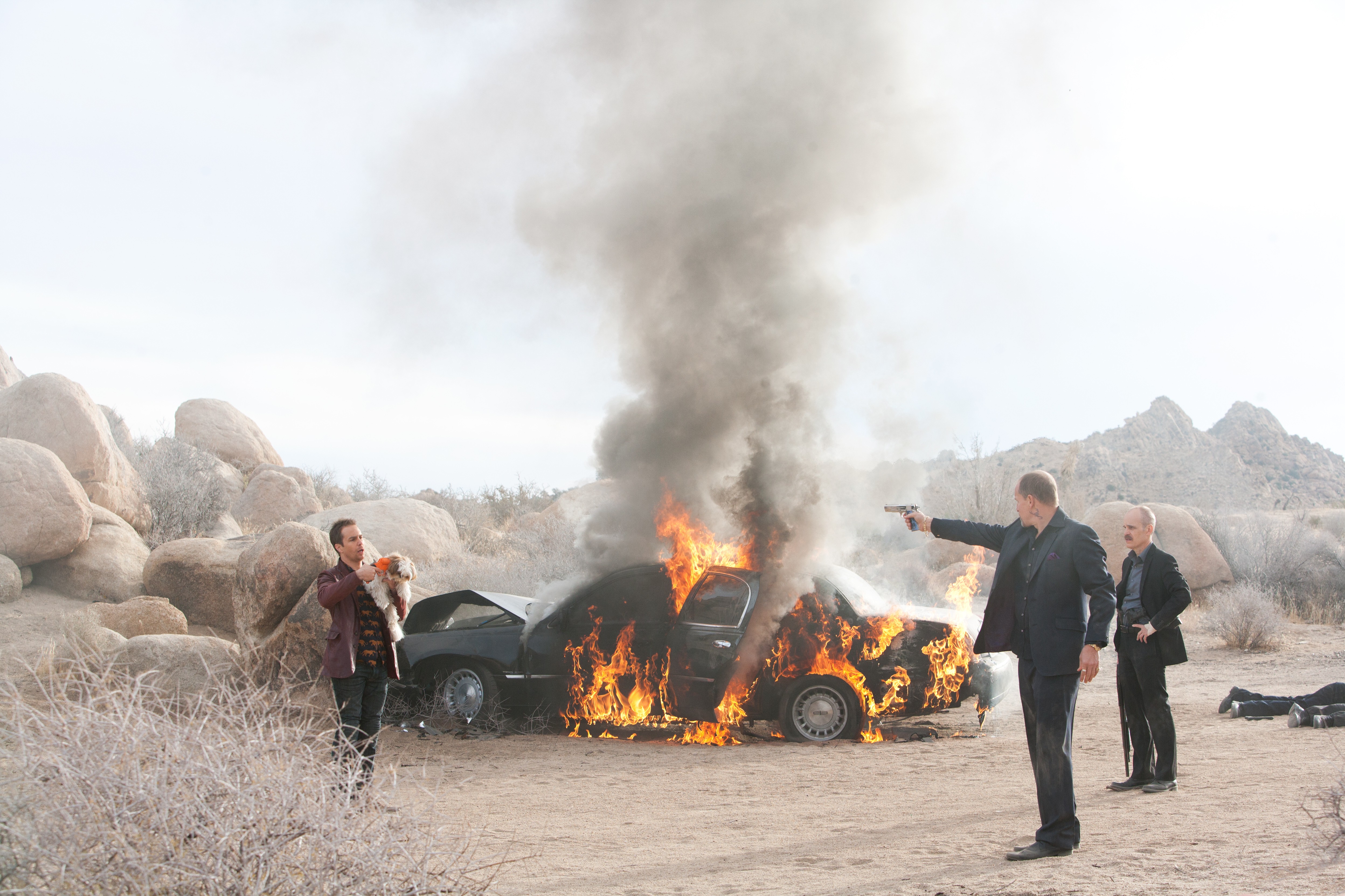 Billy from Seven Psychopaths with burning car HD Wallpaper