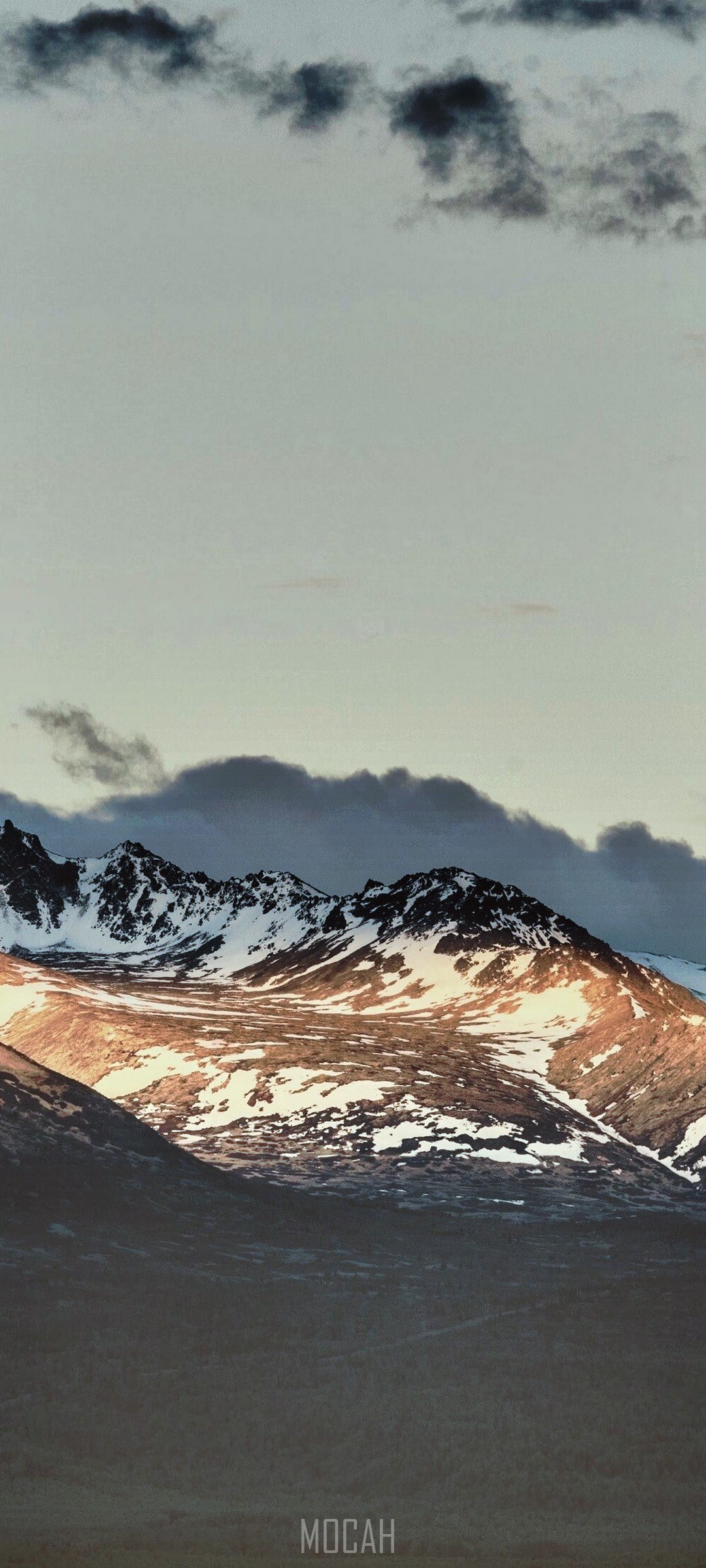 Snow-capped mountains under a cloudy sky HD Phone Wallpaper